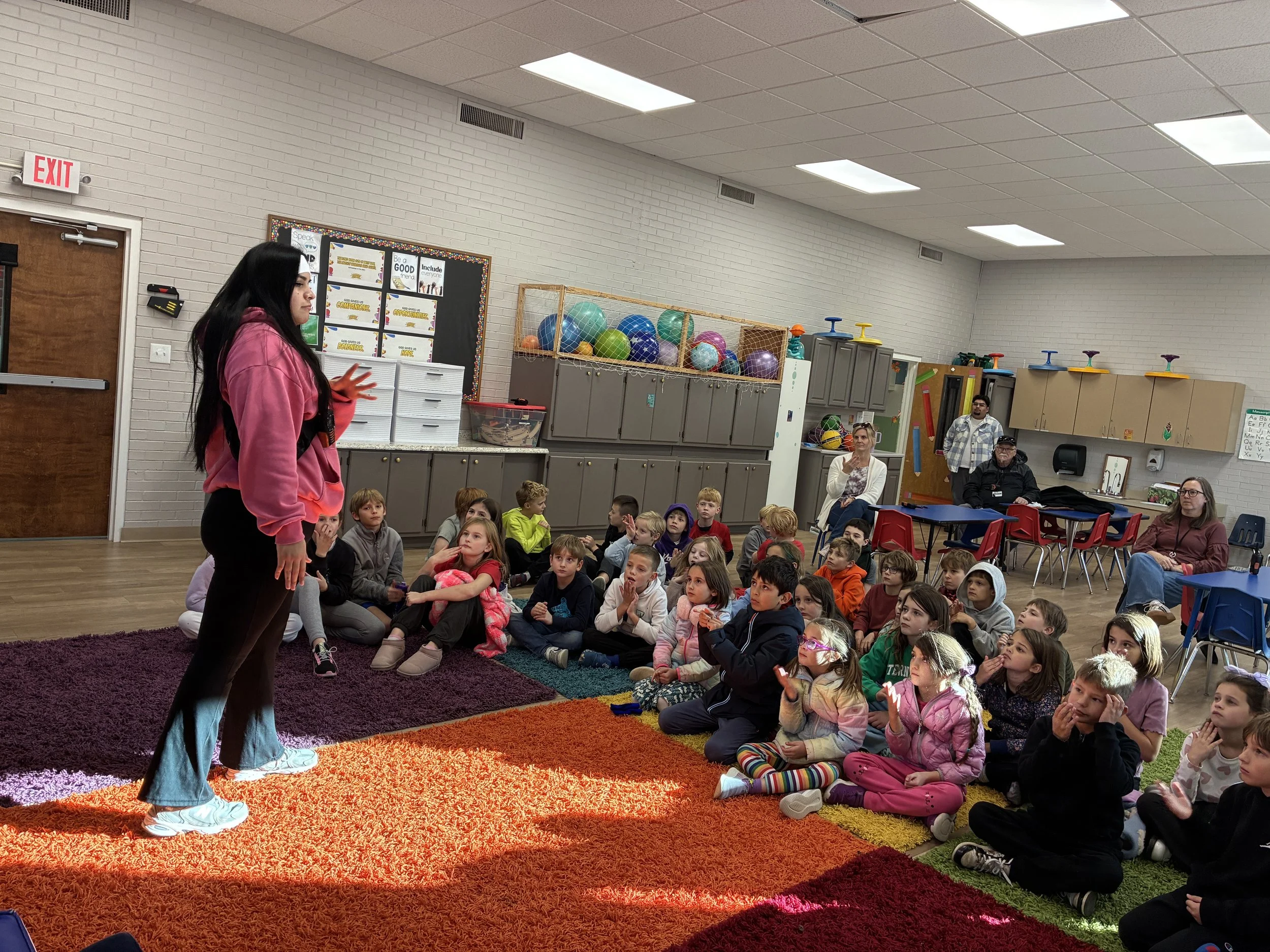 Miss Marcella teaching American Sign Language