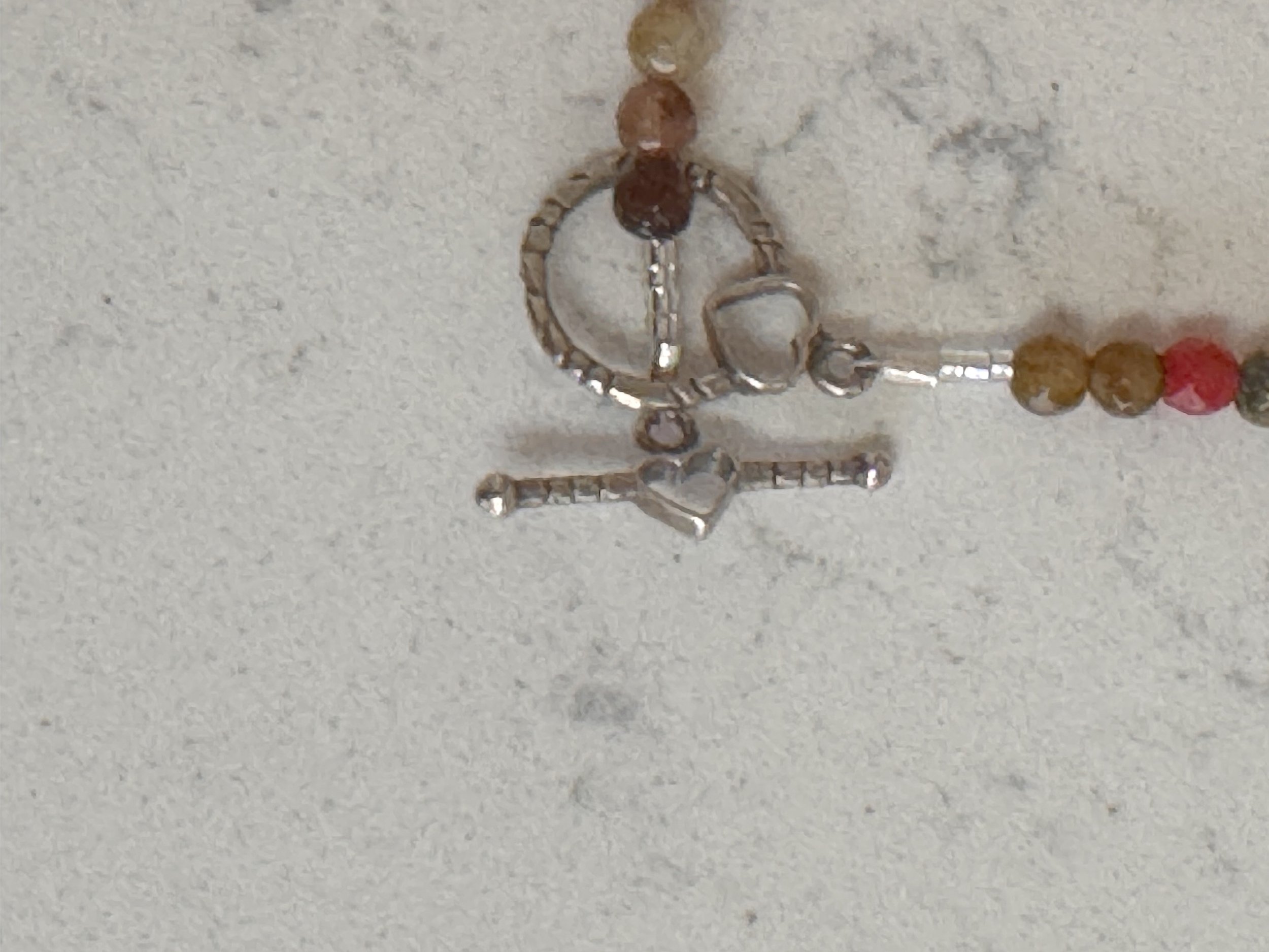 Multi faceted gems with sterling heart bracelet clasp.jpeg