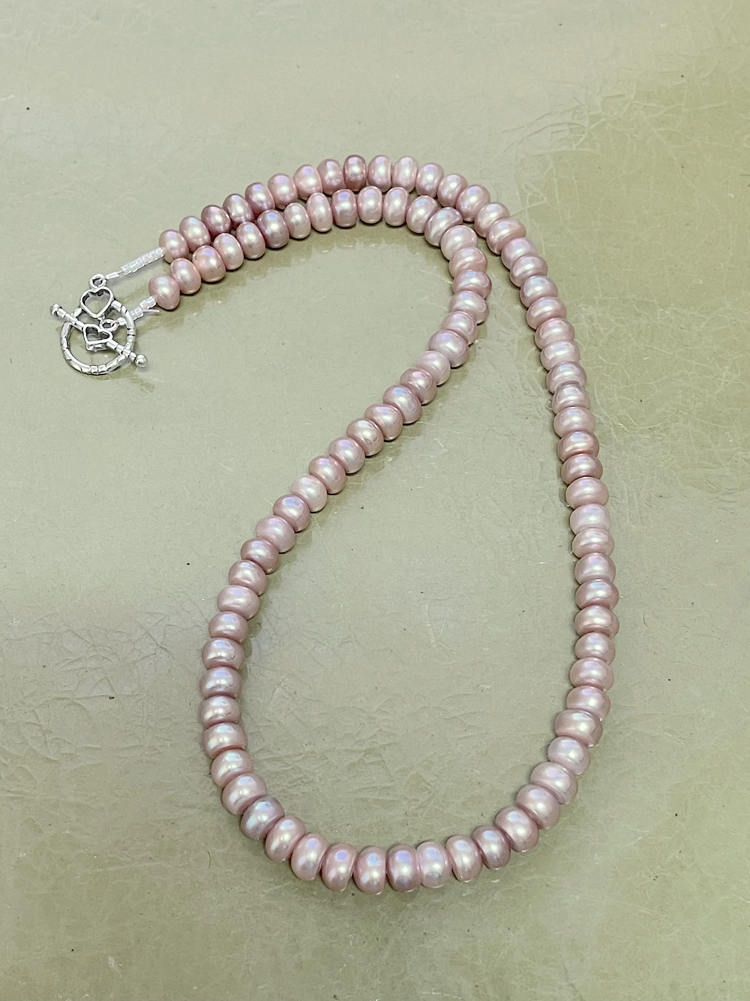 Mauve button pearls curved.jpg