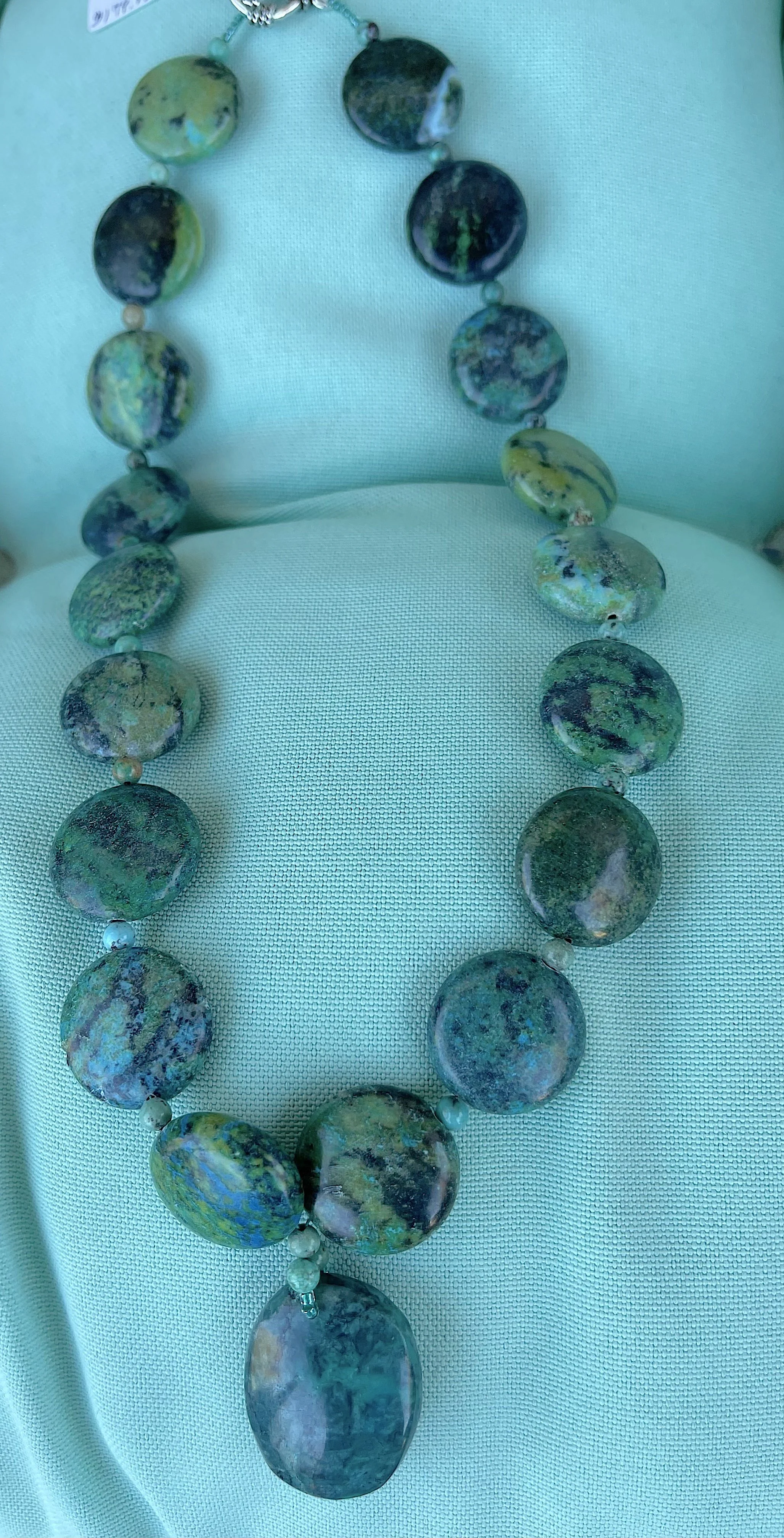 Turquoise Discs on turq. pillow.jpg