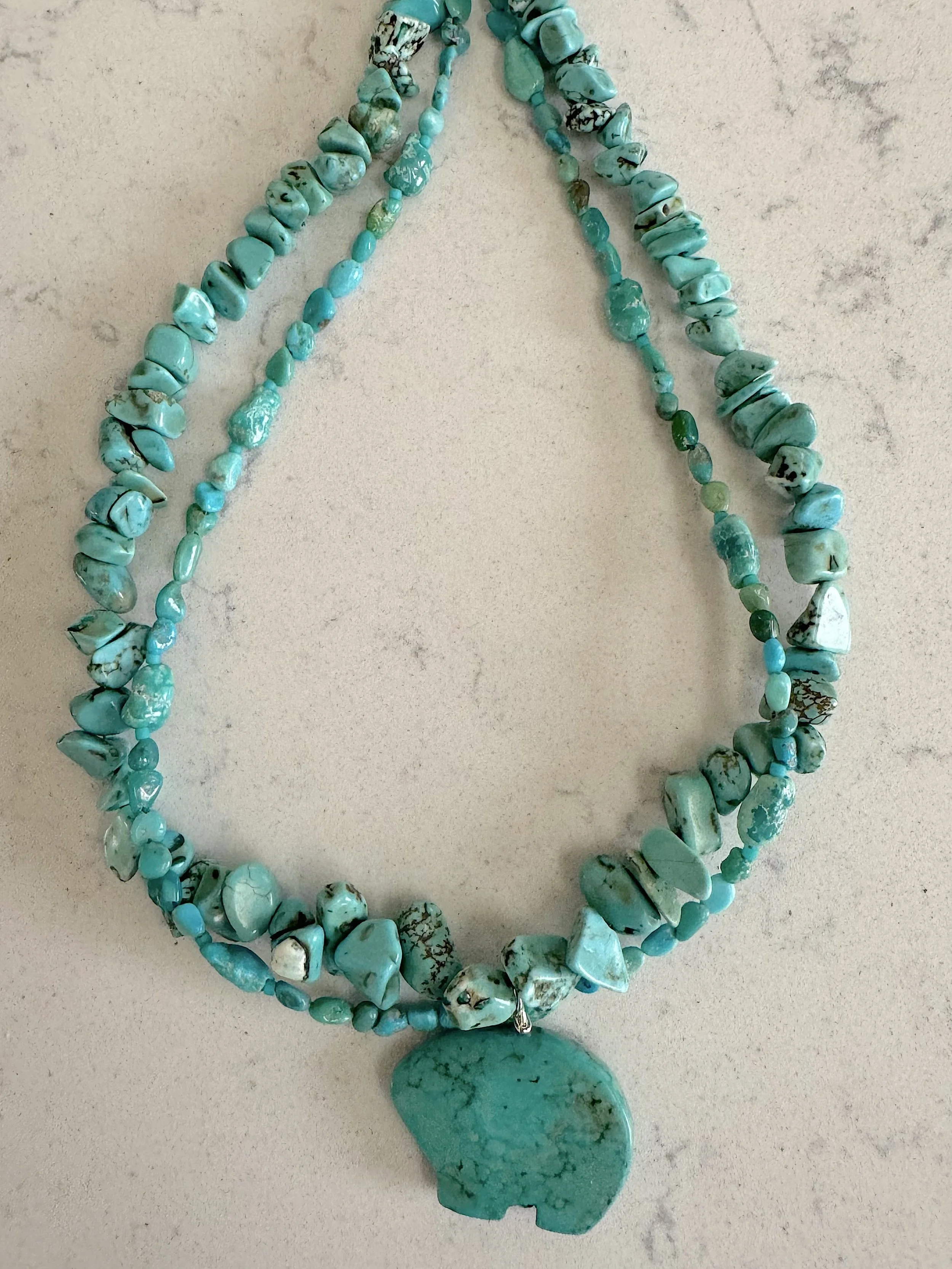 Turquoise Bear closeup on quartz.jpg