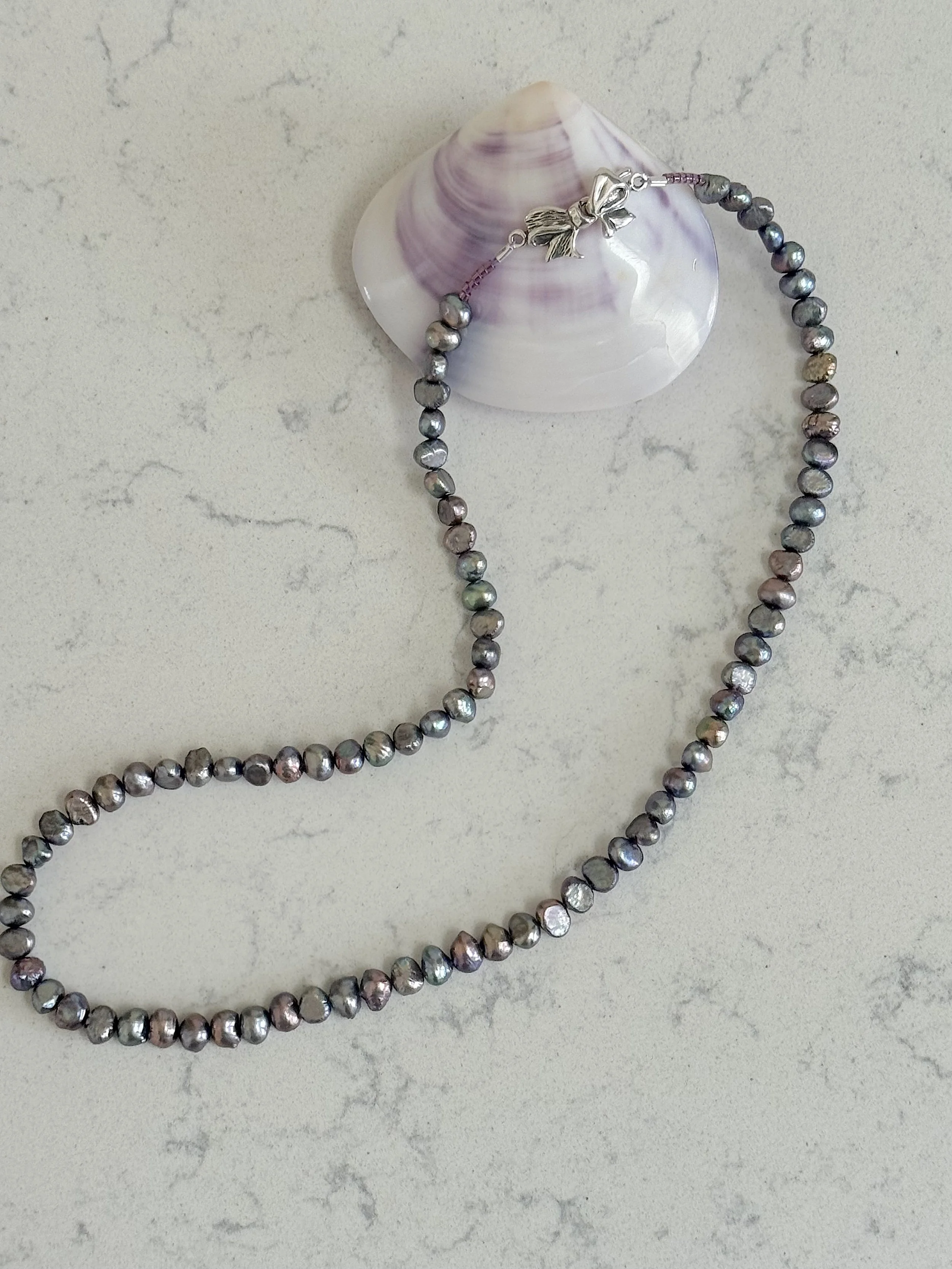 Silver Peacock pearls curved with clasp and shell.jpg