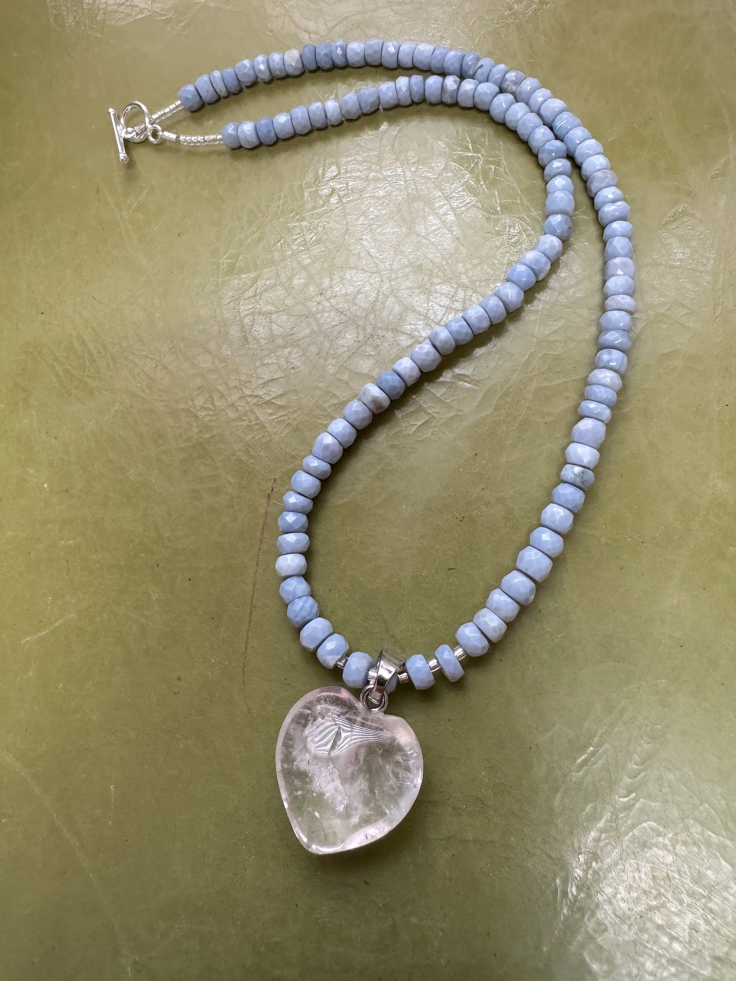 Faceted Blue Opal and clear quartz heart curved.jpg