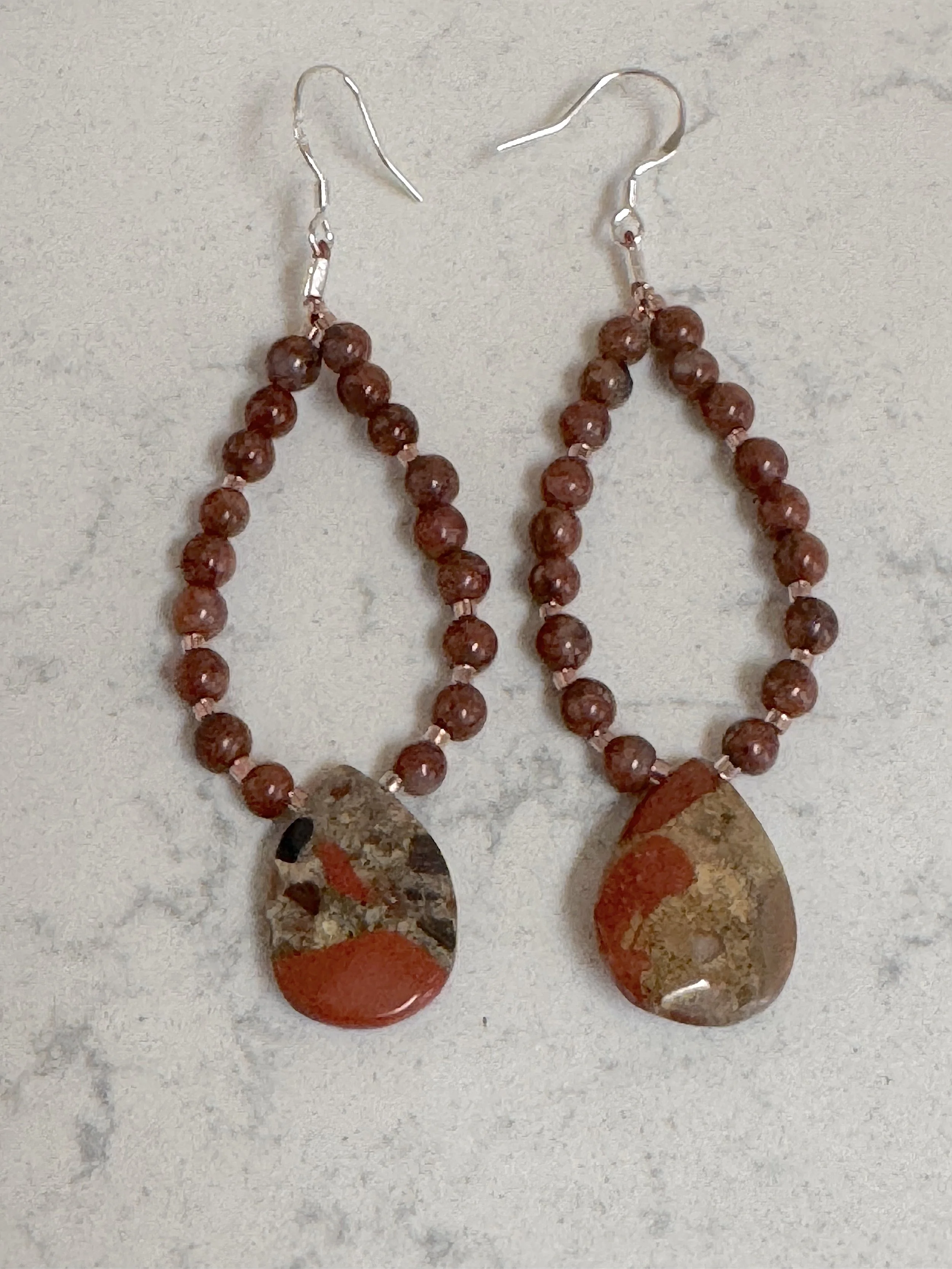 Red Picture Jasper & Spotted Chalcedony hoops on quartz.jpeg