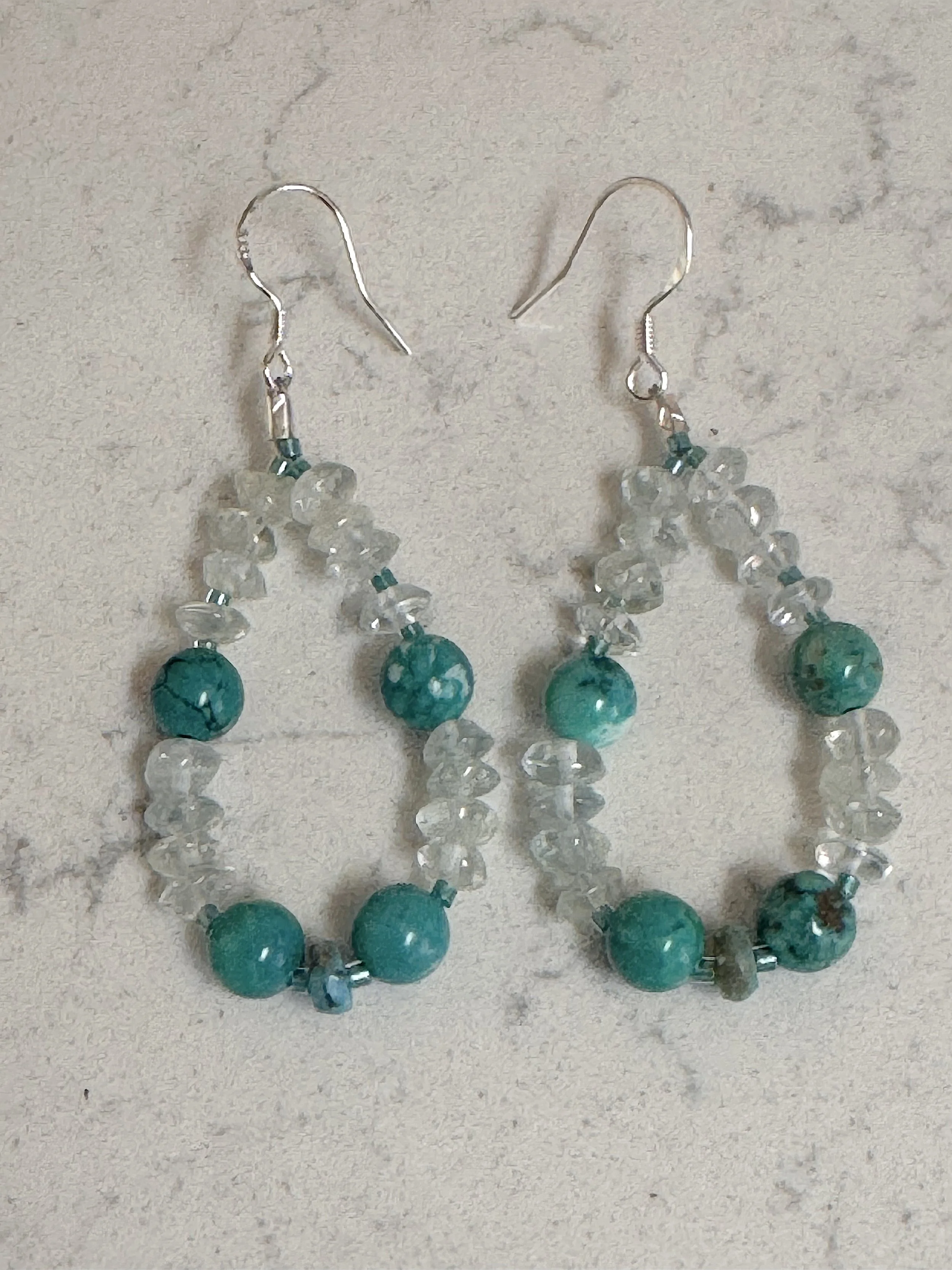 Aquamarine ad Turq hoops on quartz.jpeg