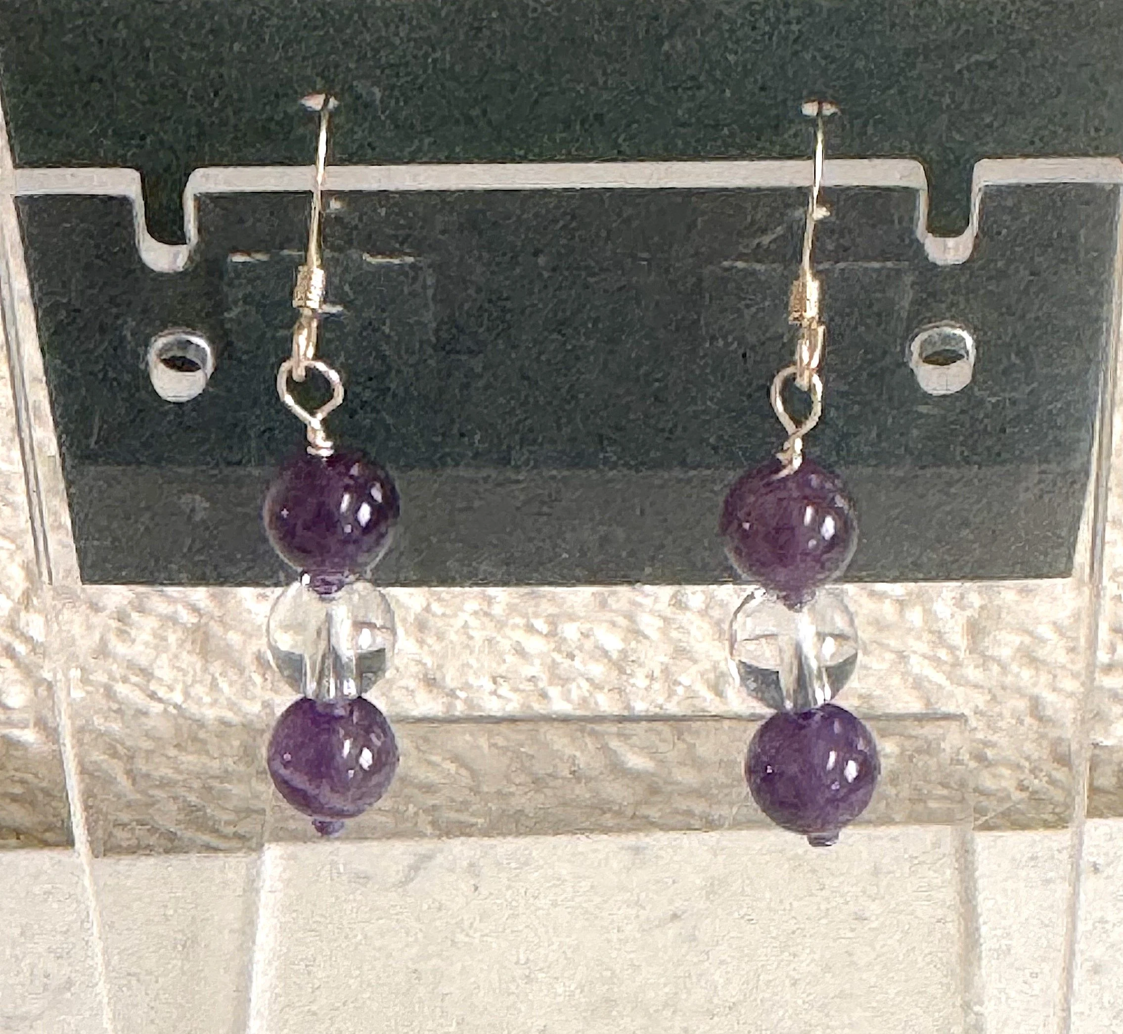 Amethyst and quartz earrings on stand.jpeg
