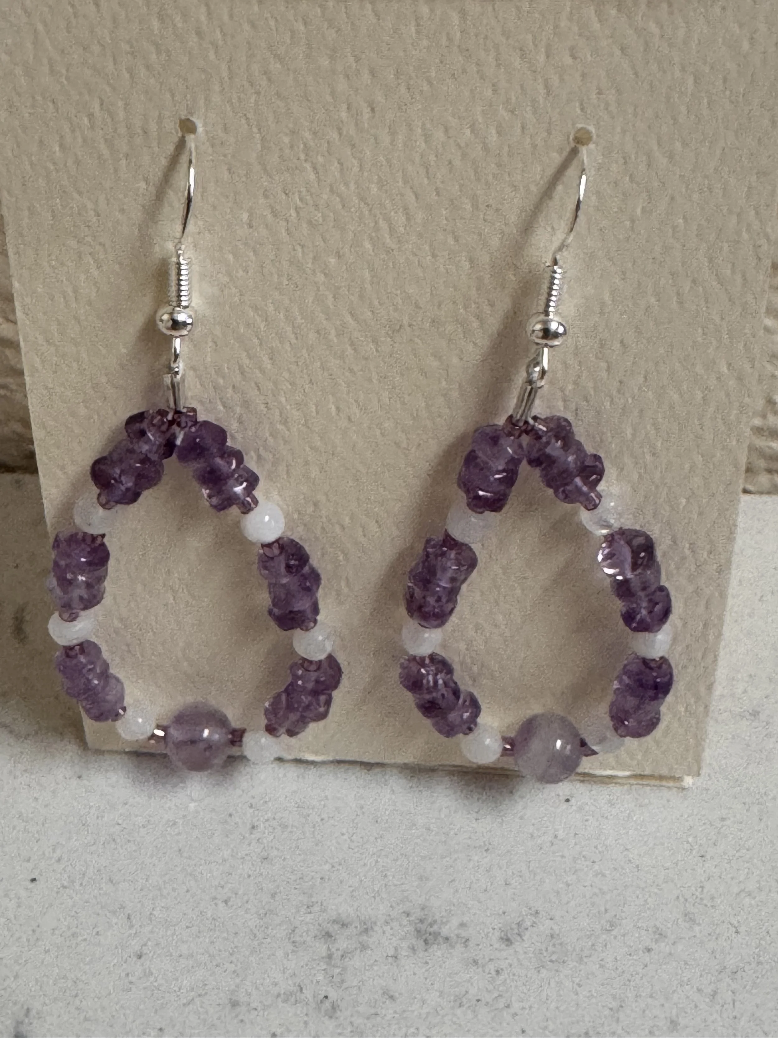 Amethyst and Rainbow Moonstone med. hoops on stand.jpeg