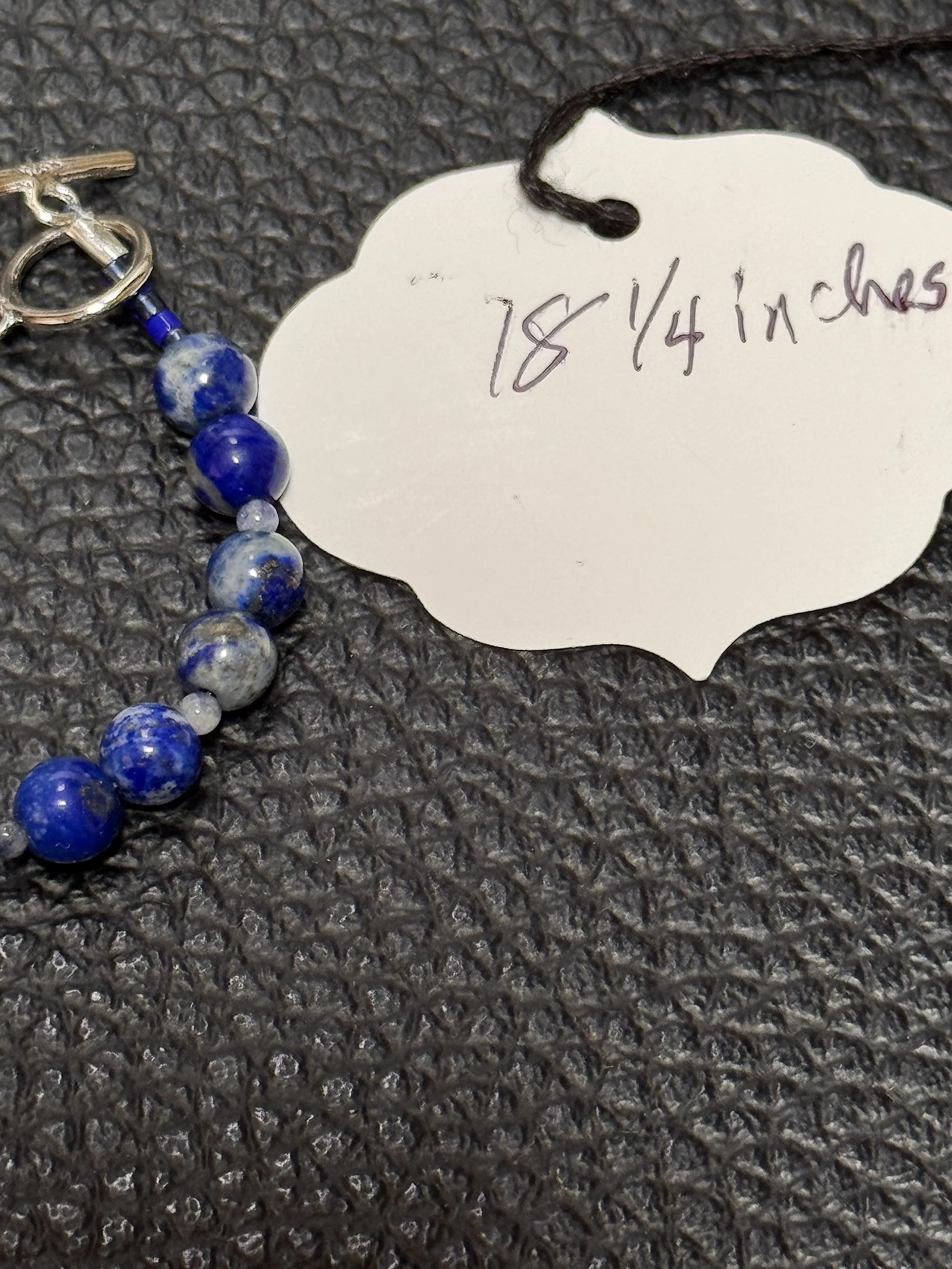 Kokopeli on Lapis info tag.jpeg