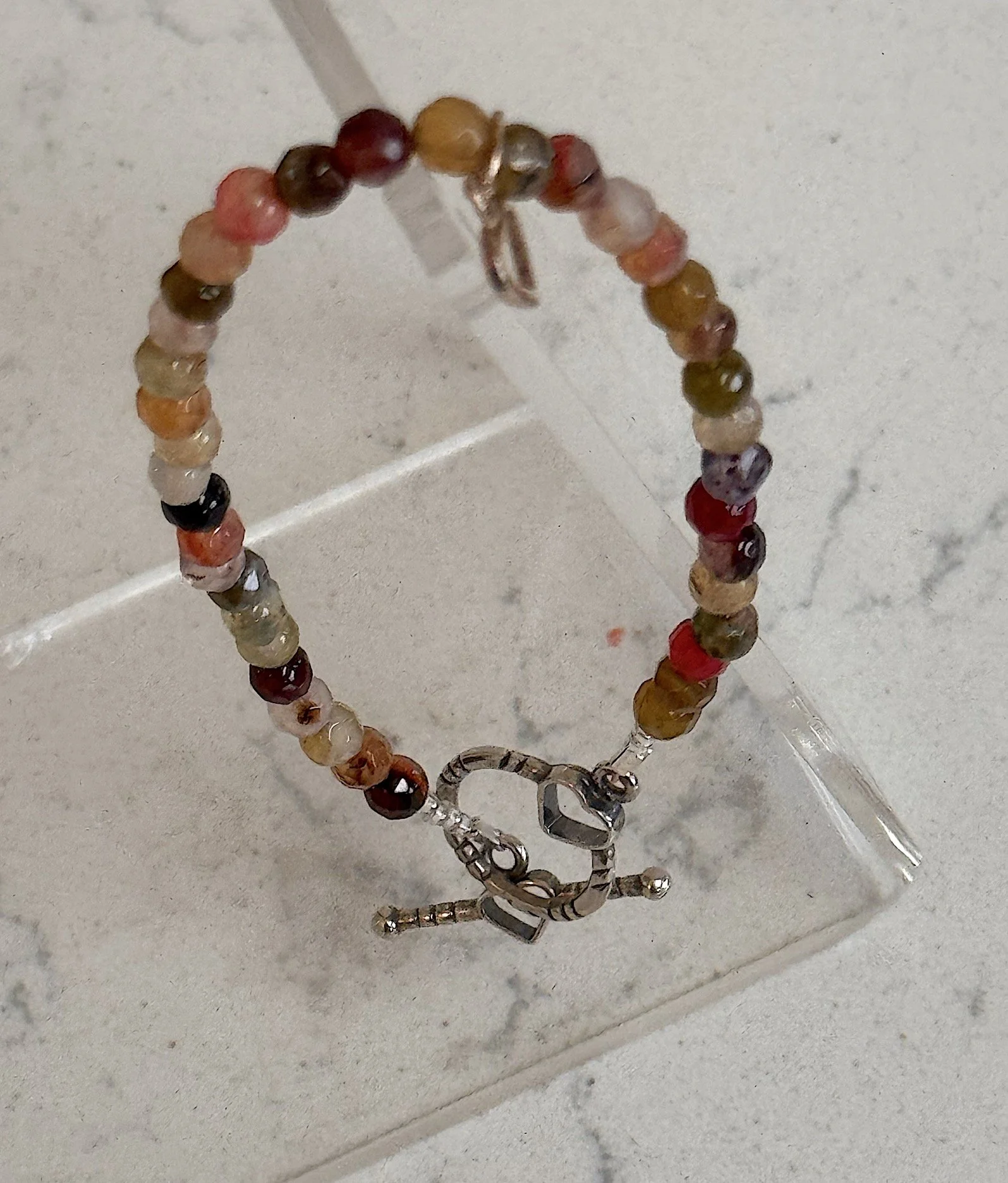 Multi faceted gems with heart on stand.jpeg