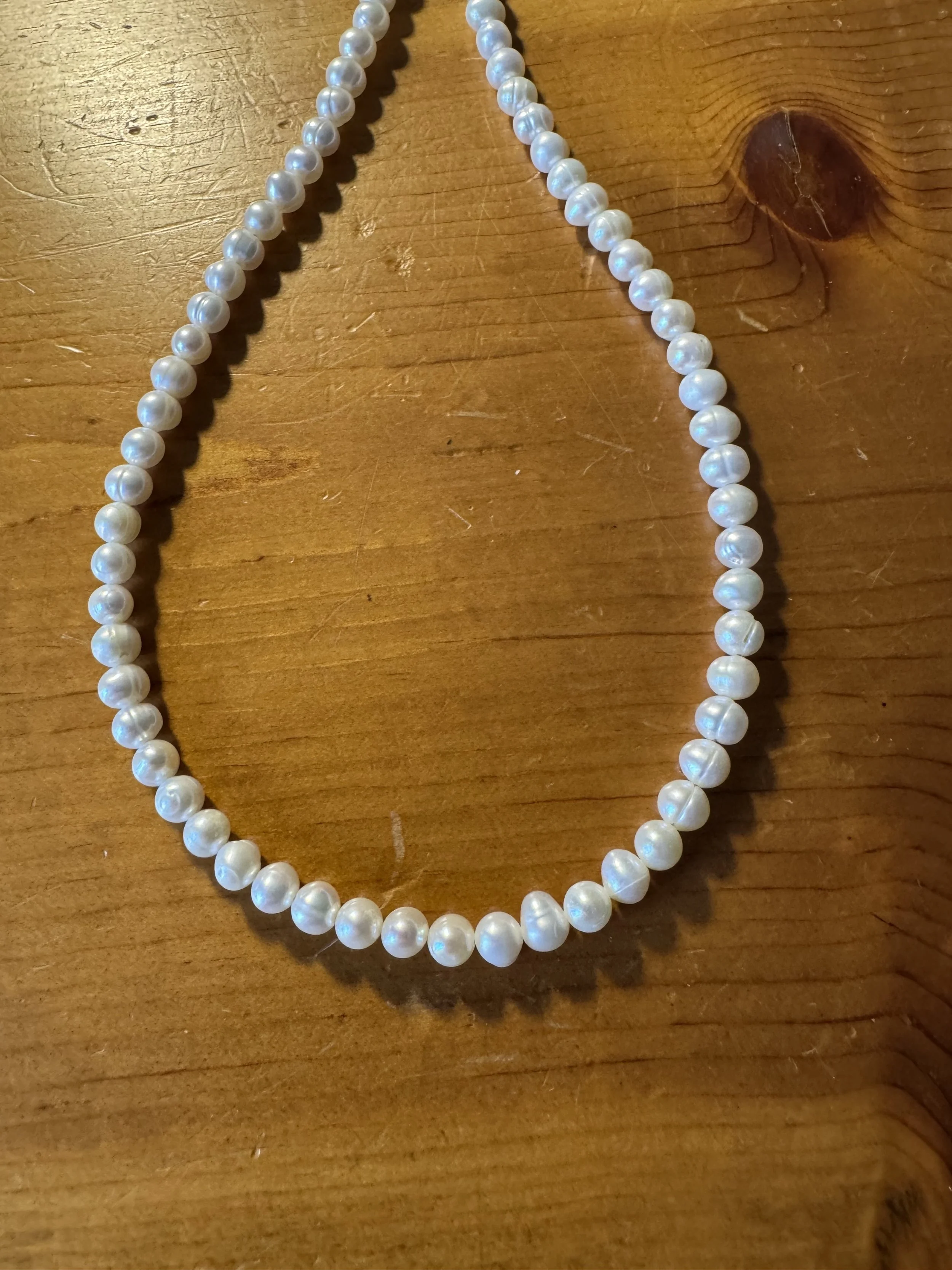 Cultured white pearls with gold clasp closeup.jpg