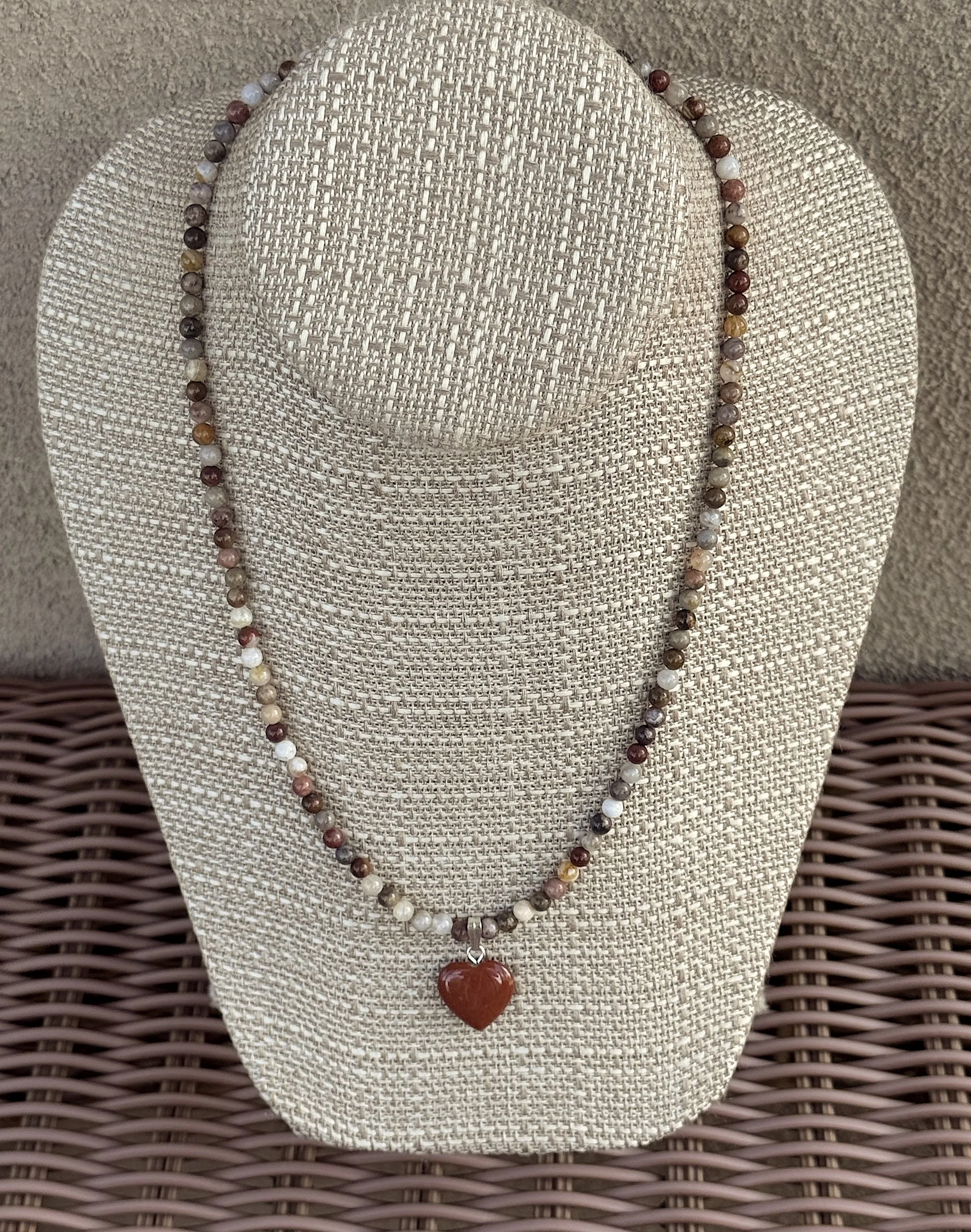 Bamboo Agate and Red Jasper heart on wicker.jpeg