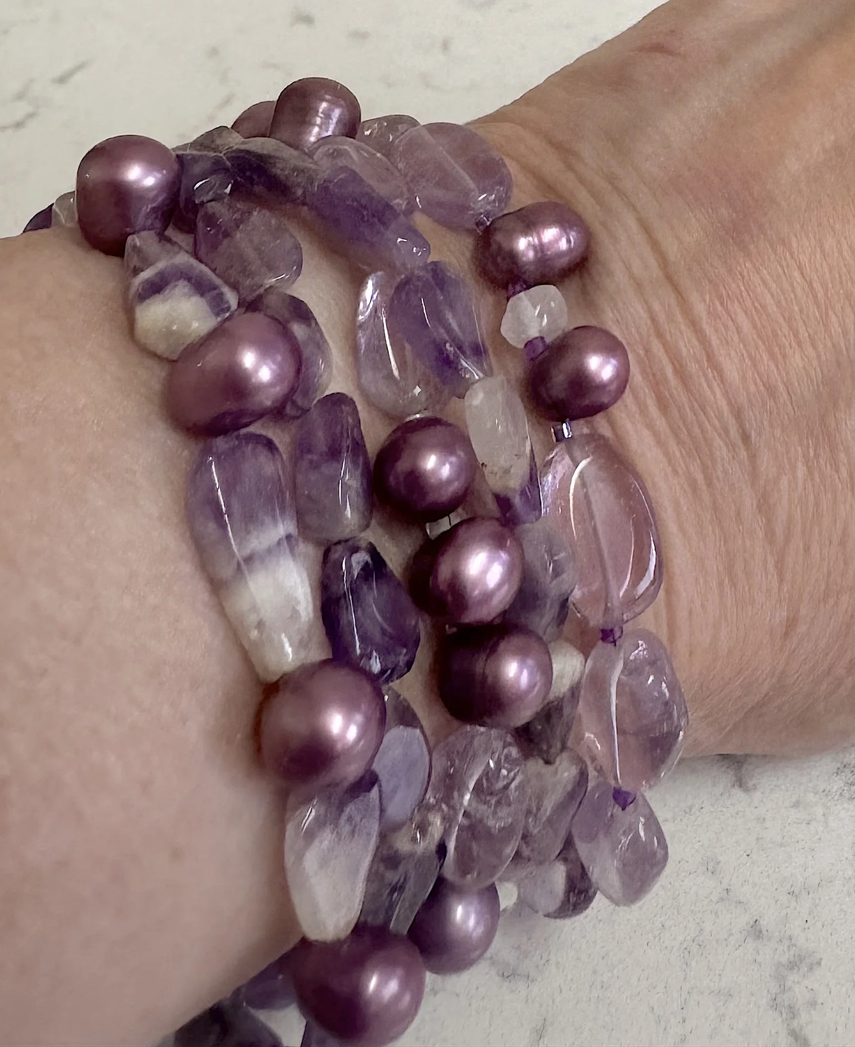 Purple Flowers Bracelets and necklace on wrist.jpeg