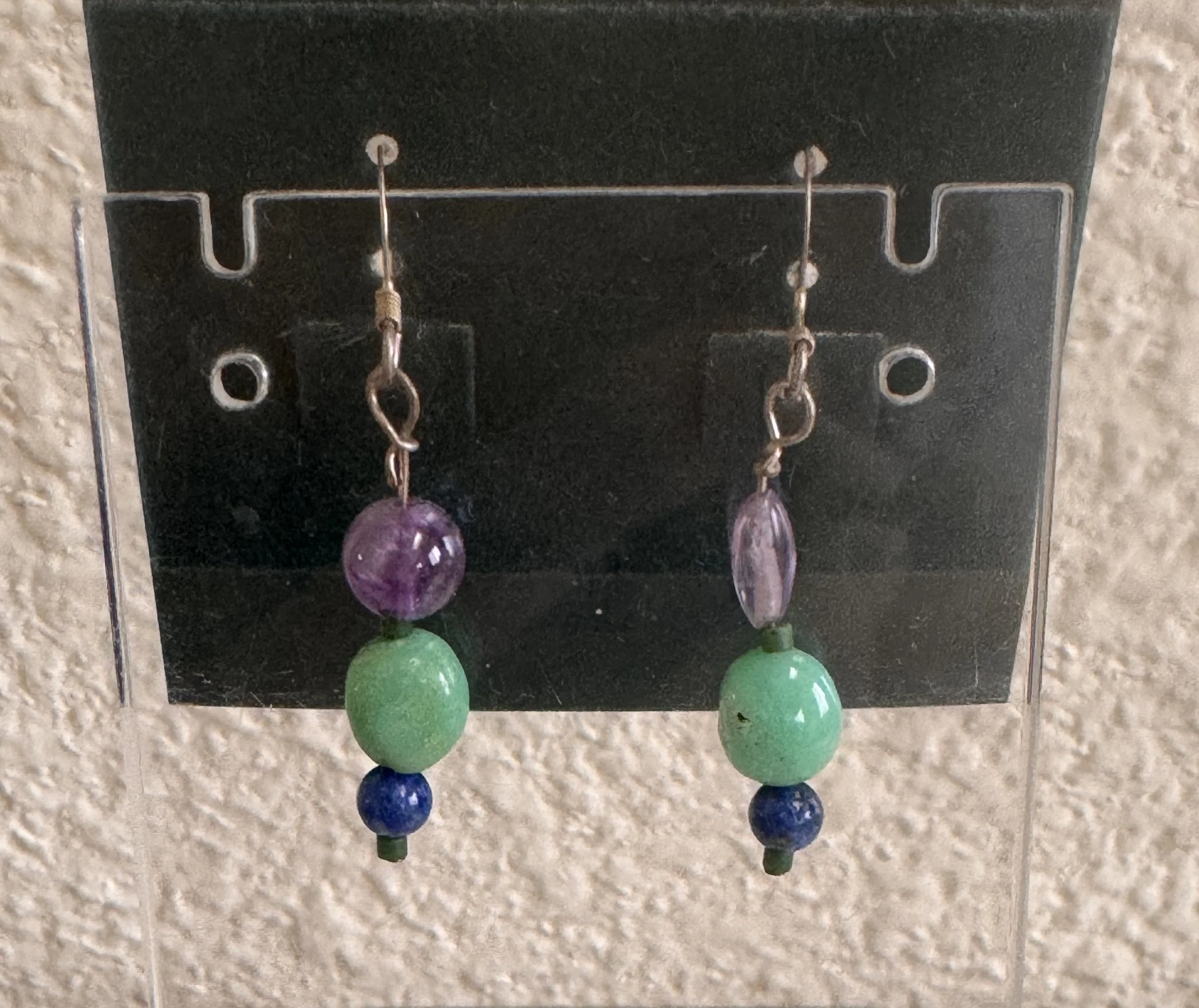 Early Blueberries earrings on stand.jpeg