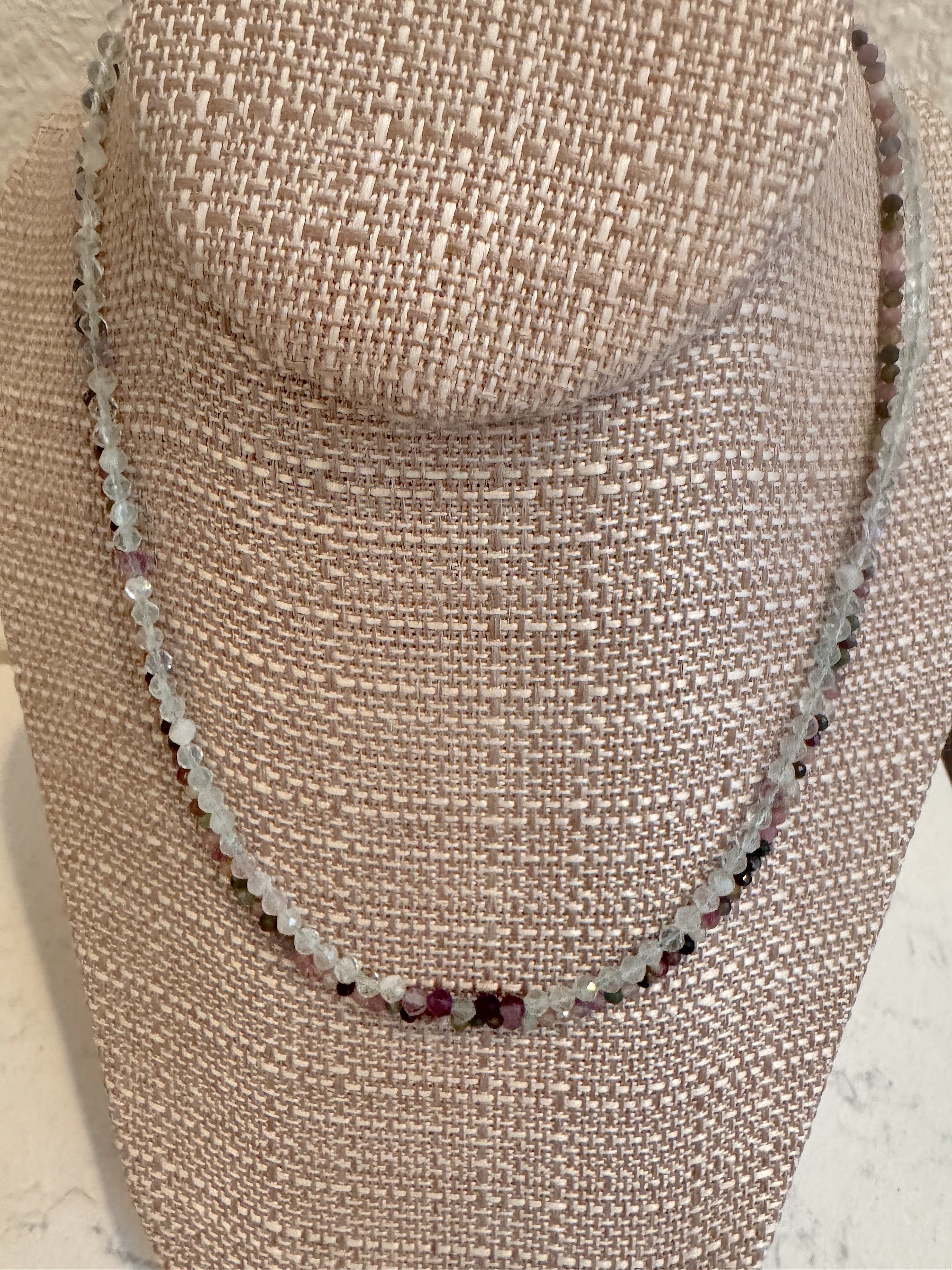 Tiny Tourmallie and faceted fluorite on stand.jpeg