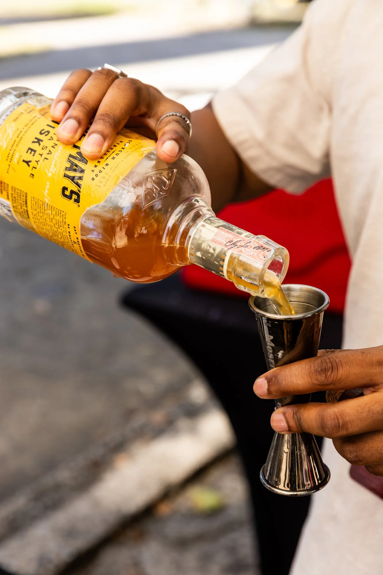 Person pouring whiskey into a jigger. Southbound Food Festival in Birmingham, Alabama.