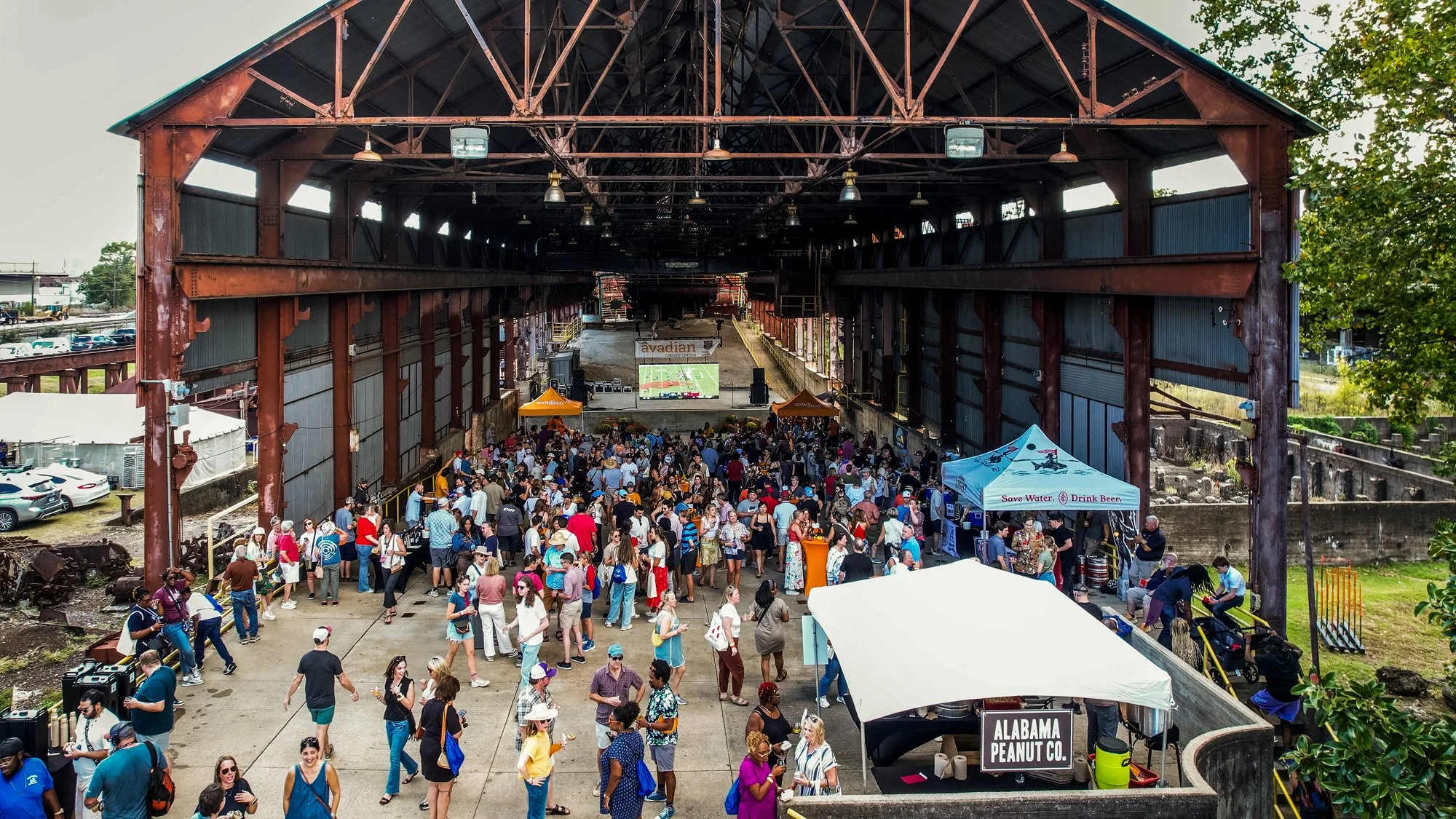 Large crowd gathered in a venue with a high, open steel roof, attending an outdoor event or festival. Southbound Food Festival in Birmingham, Alabama.