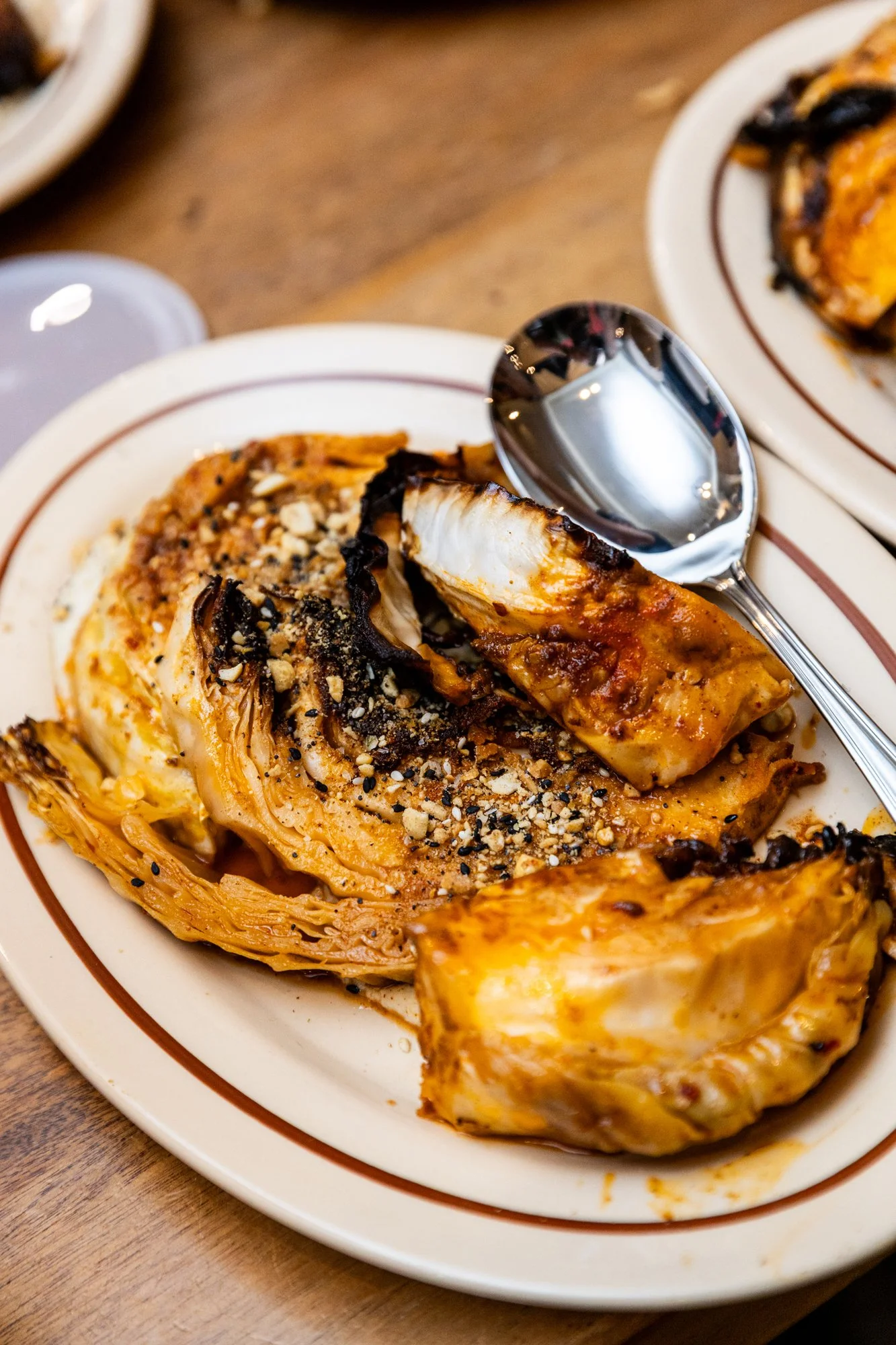Cooked cabbage sprinkled with crushed nuts on a white plate. Southbound Food Festival in Birmingham, Alabama.