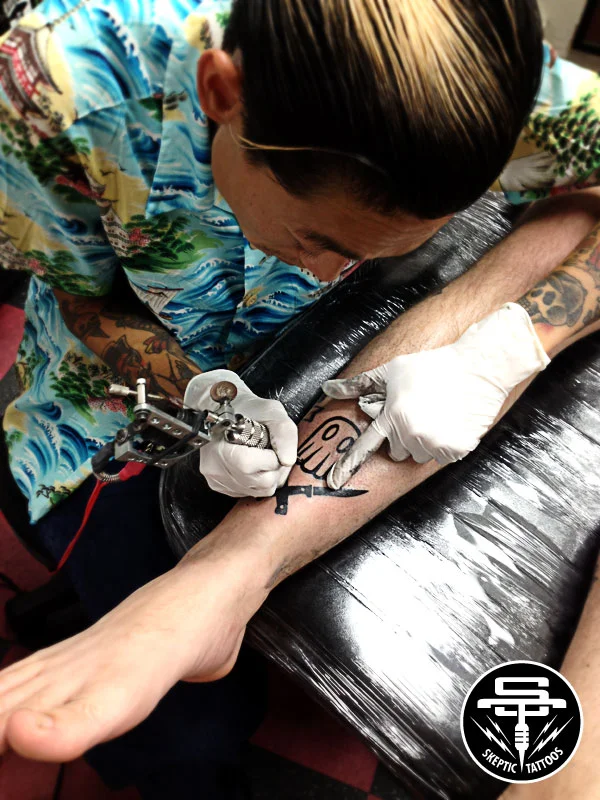 Beam tattooing Steven at Sid's Tattoo Parlor.