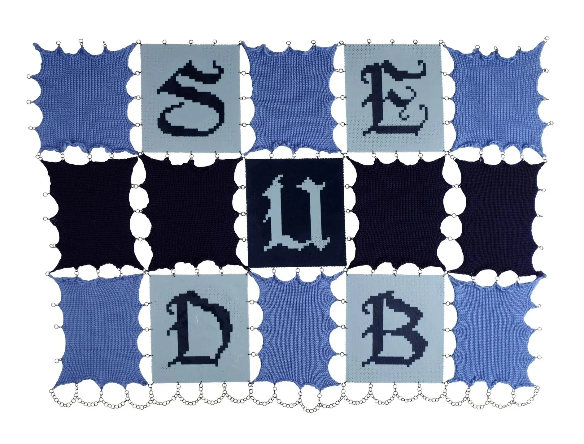 Light and dark blue knitted squares connect to perler bead squares. The squares have letters made from light and dark blue perler beads in Olde English Font spelling out the word SUBDUE.