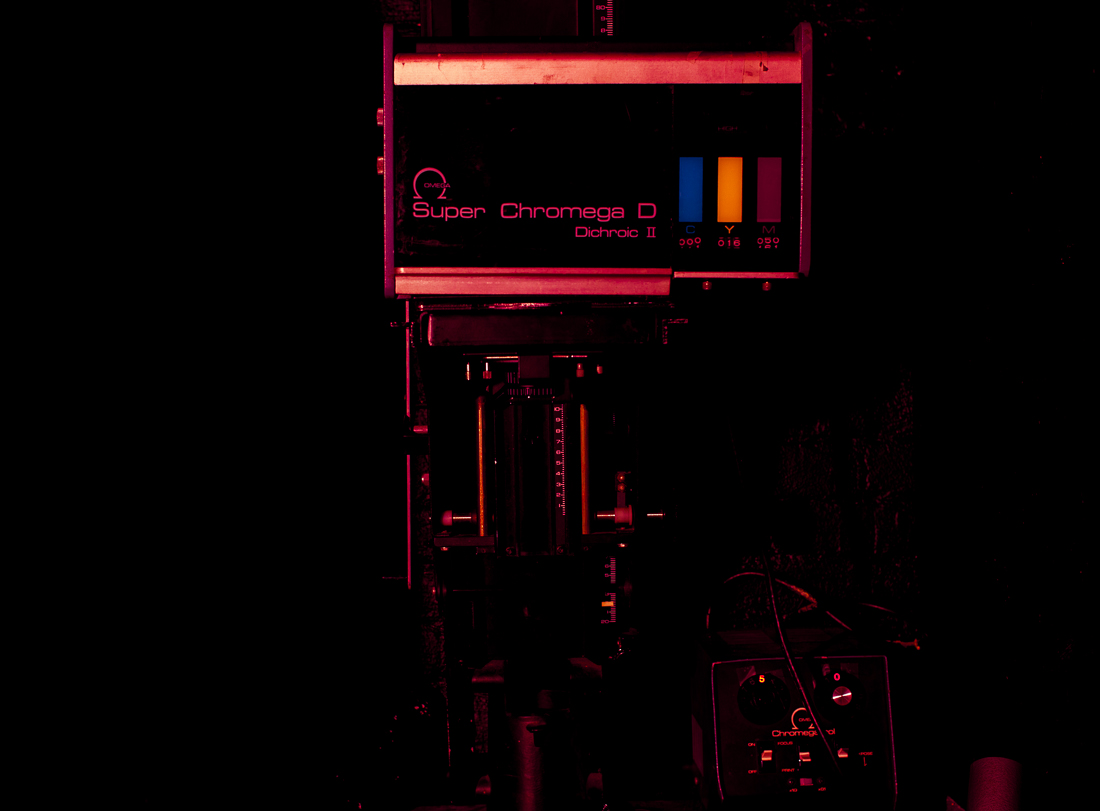 ABOVE: The Omega Super Chromega D color enlarger. Located at the Gowanus Darkroom . A true workhorse enlarger, the dichronic head allows for color filtration for correcting color casts for printing color, as well as adjusting contrast for variable contrast (VC) black & white papers. These darkroom staples are built to last a long time, with easily accessible parts for replacement and repair. Given that working enlargers are often found over 20 years old, the quality of build and materials is top-notch, and the accompanying digital timers are reliable and easy to use. 