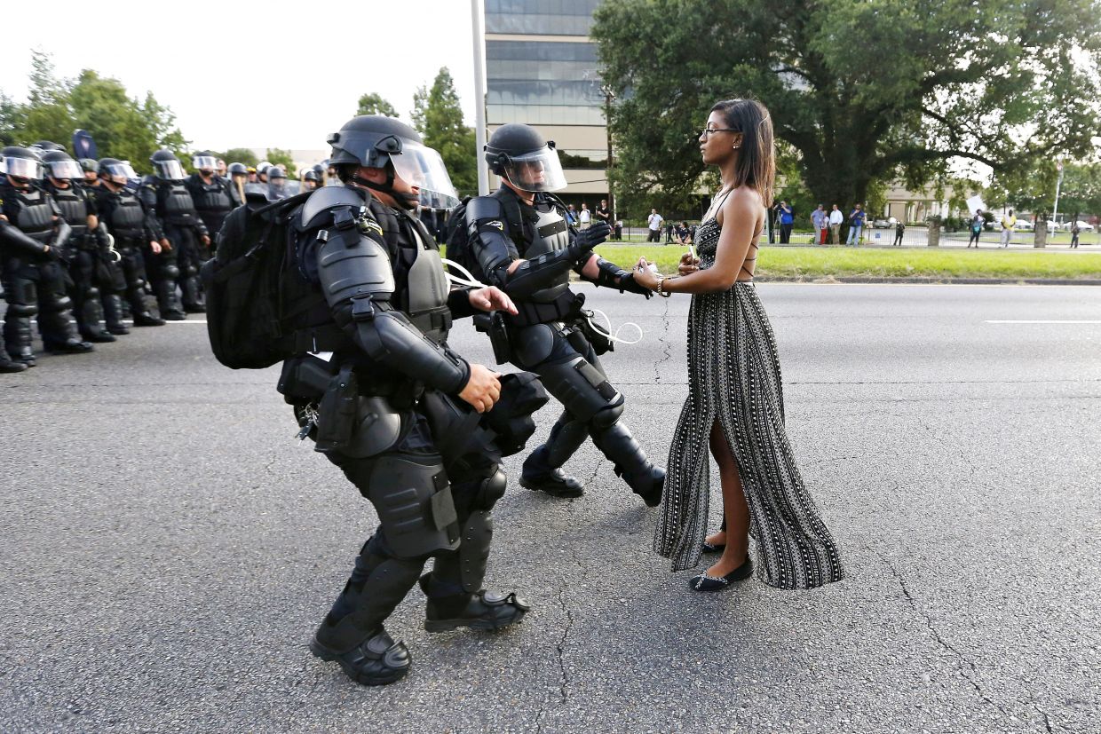 Protester in Baton Rouge 2016 Jonathan Bachman (Reuters) “I photographed someone arguing with an officer and then I looked over my shoulder and saw her there and she had every intention of not moving,” Bachman told BuzzFeed News . “She just stood there and made her stand. I was just happy to be able to capture something like that.” The woman, identified as 28-year-old Ieshia Evans, stands in extreme contrast to the heavily-armored SWAT team members who are engaged in arresting her. 
