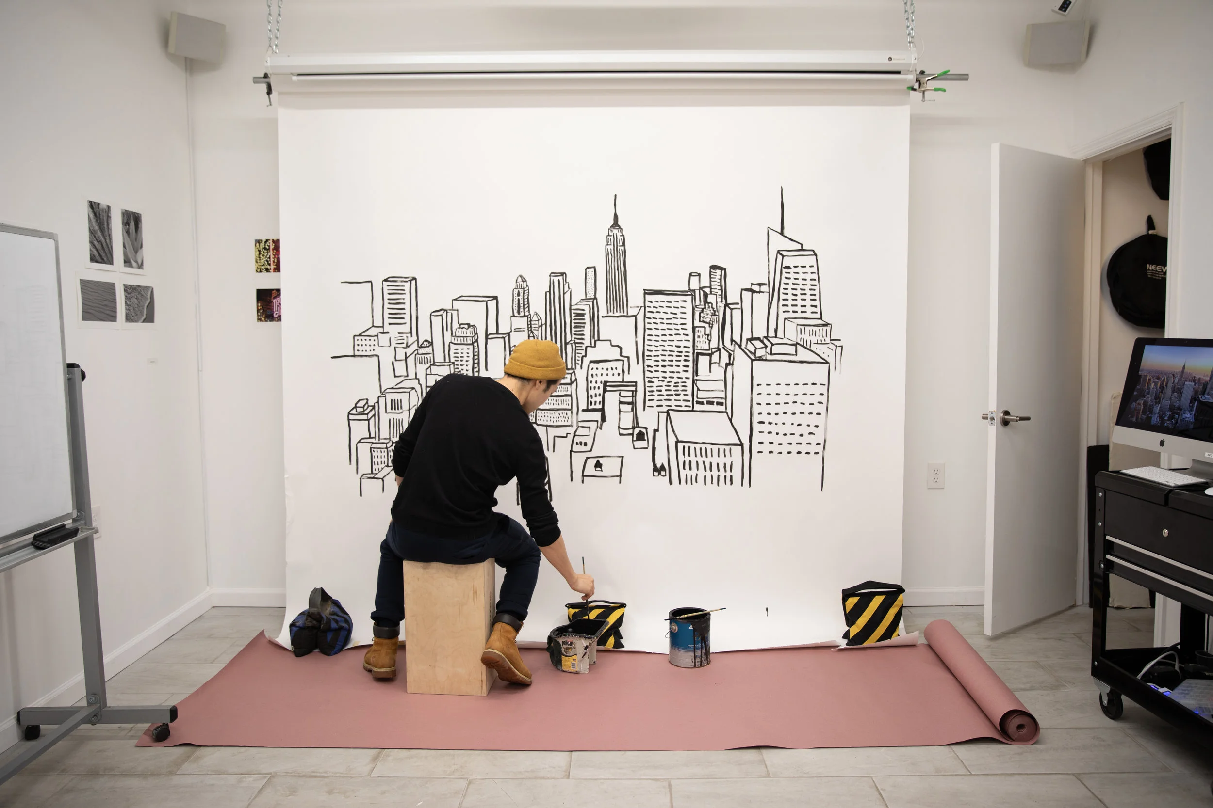 Pre-pro BTS! Justin hand-painting NYC skyscrapers on our seamless to create a festive cityscapes backdrop.