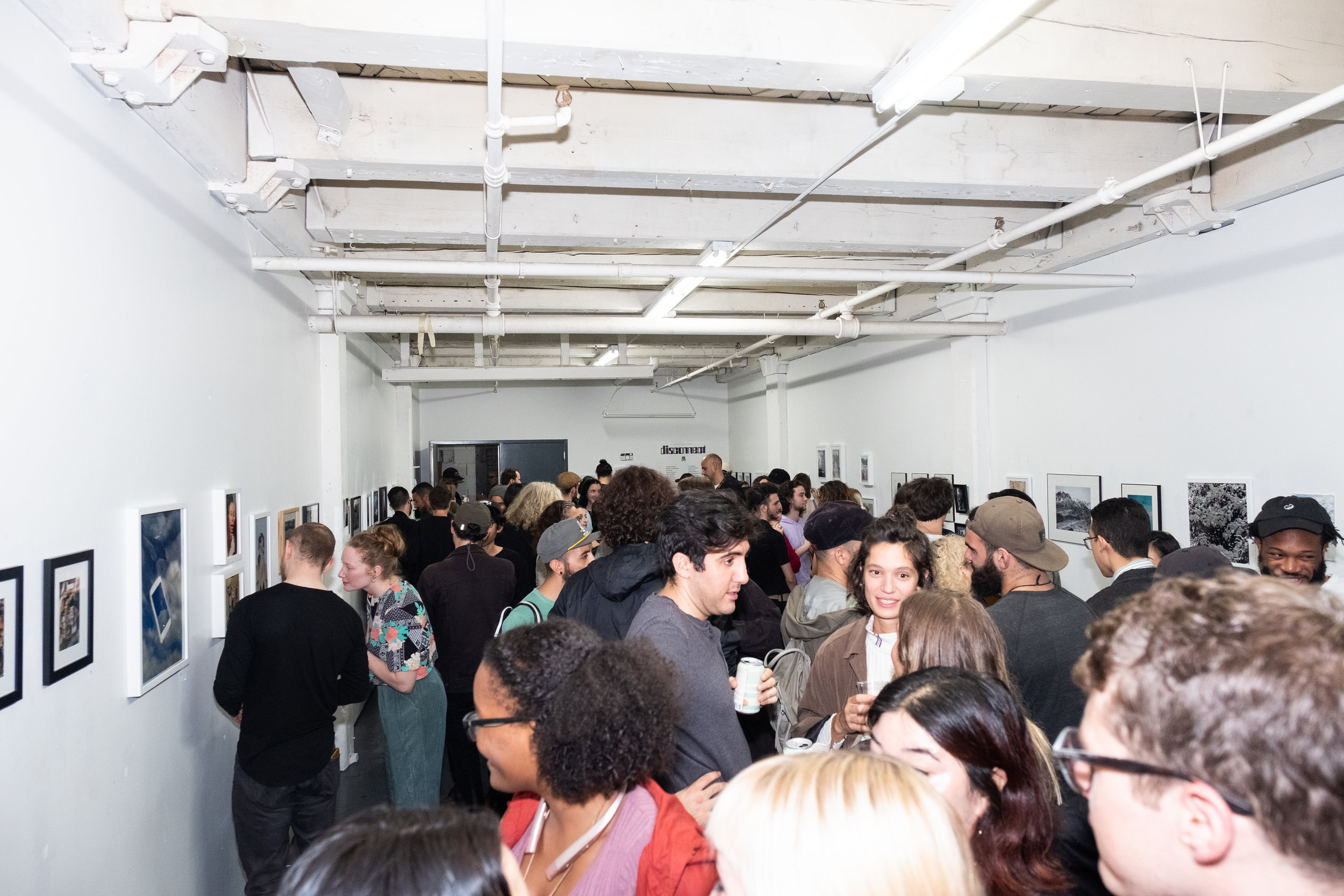 A packed house for Disconnect group photo show at Contact Gallery.
