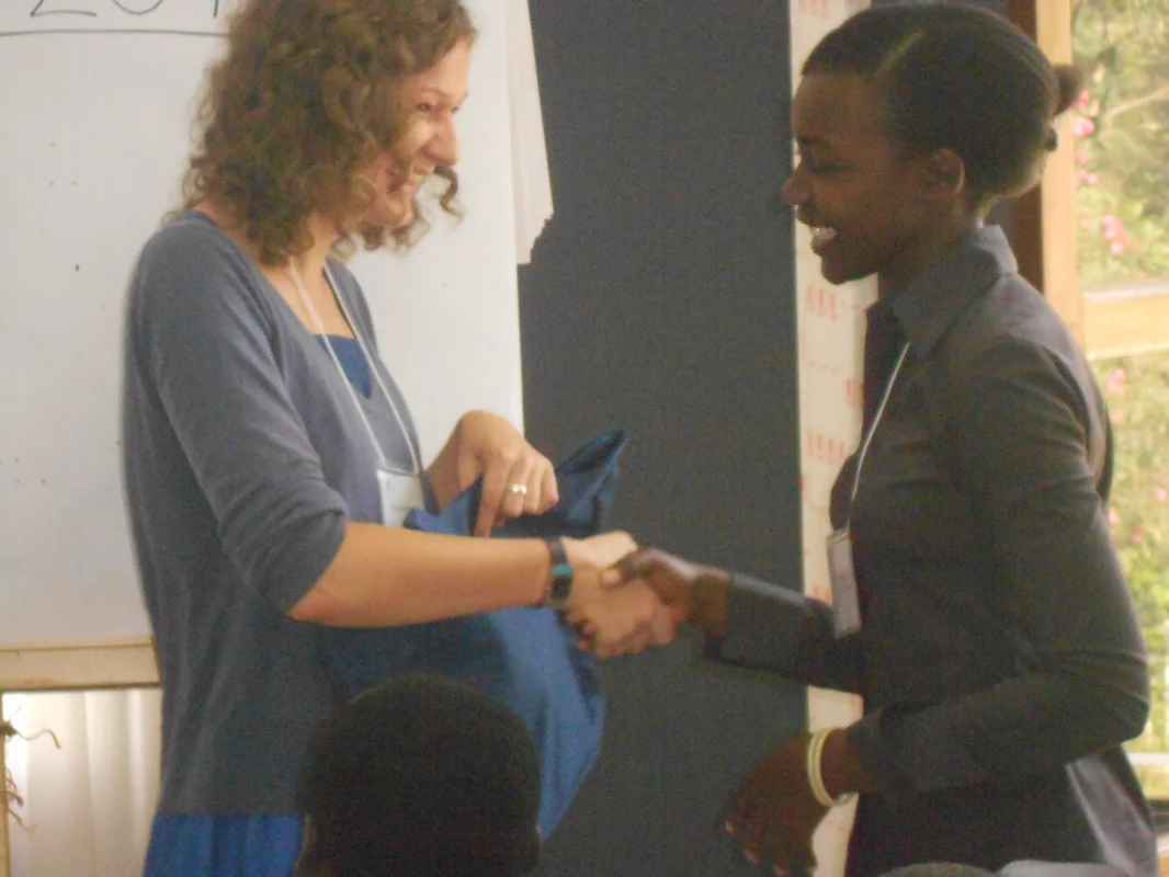EIHR Kigali 2011-41-Kinga received a thank you present from a conference participant. Miss Krzeminska was the primary translator for irena Sendler during the last few years of here life.jpg