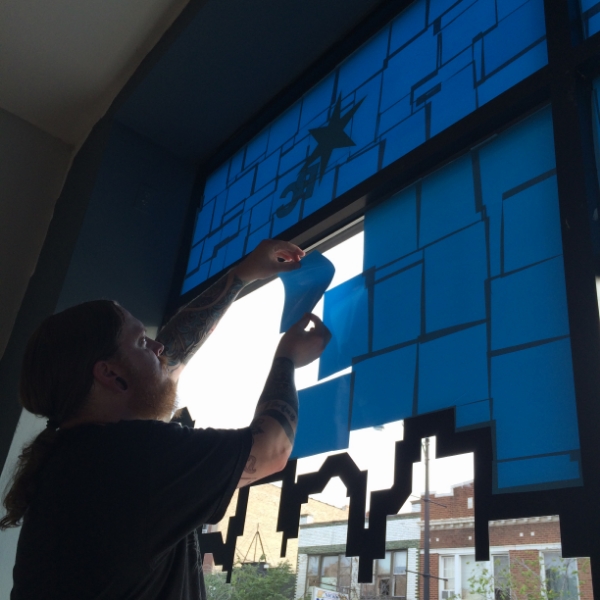 Jeremy putting up the vinyl in 4427.