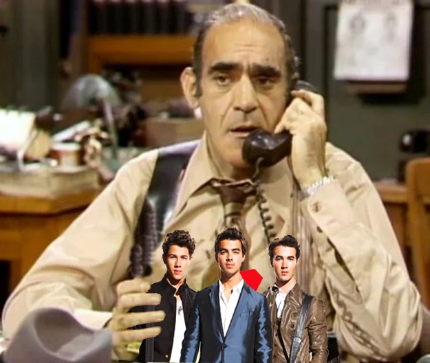 JONAS AND THE GREAT BIG FISH: That's the jonas brothers in the hand of fish, a character on barney miller played by abe vigoda