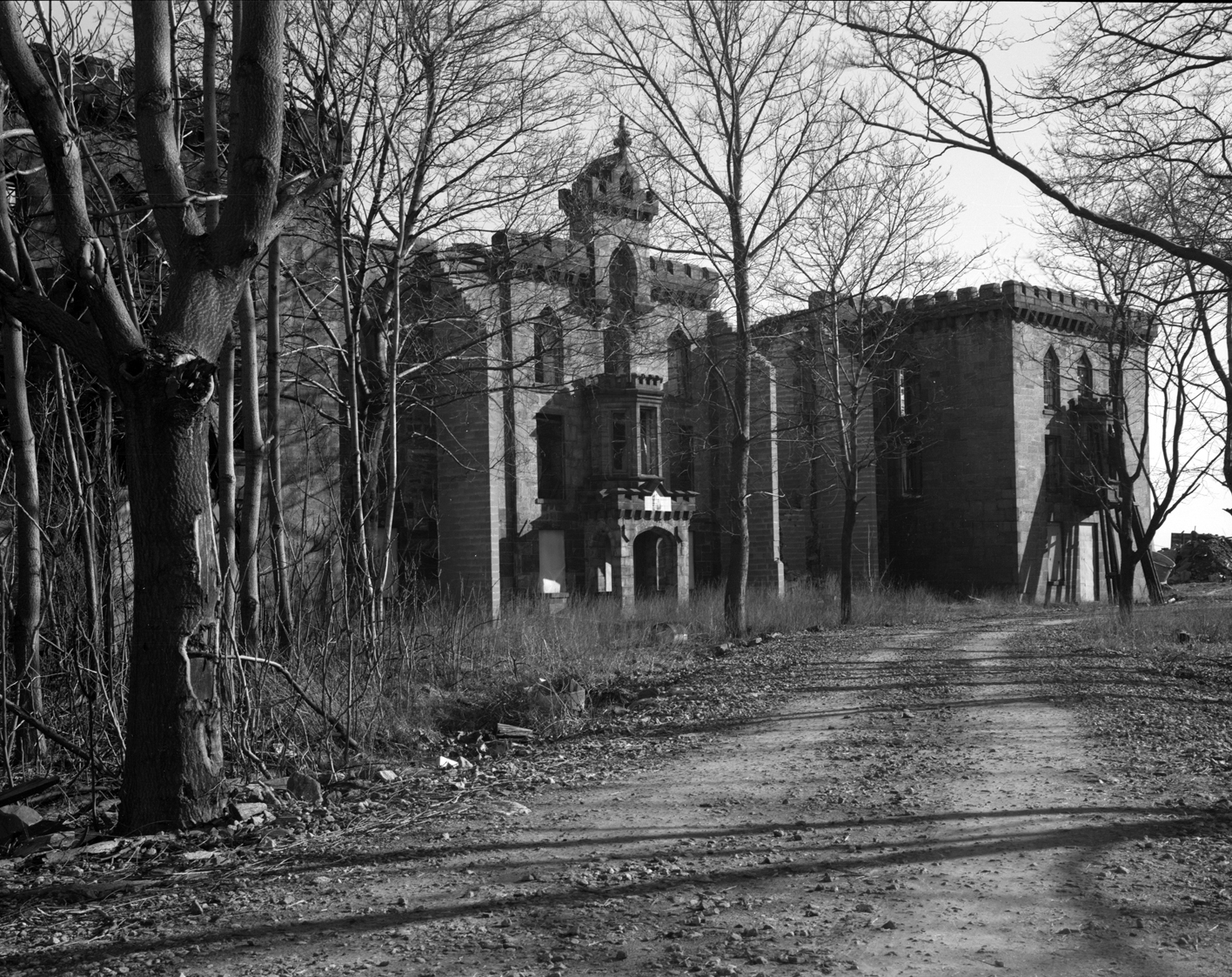 In 1976, the main façade of the Smallpox Hospital was more intact and the building was surrounded by many more trees, New York City Landmarks Preservation Commission