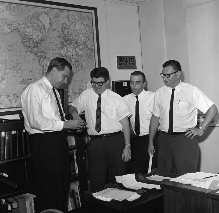 Standing left to right, Dr. Donald A. Henderson, Dr. J. Donald Millar, Dr. John J. Witte, and Dr. Leo Morris in one of the Centers for Disease Control and Prevention’s (CDC) former offices. Dr. Donald A. Henderson, headed the international effort during the 1960s to eradicate smallpox. CDC