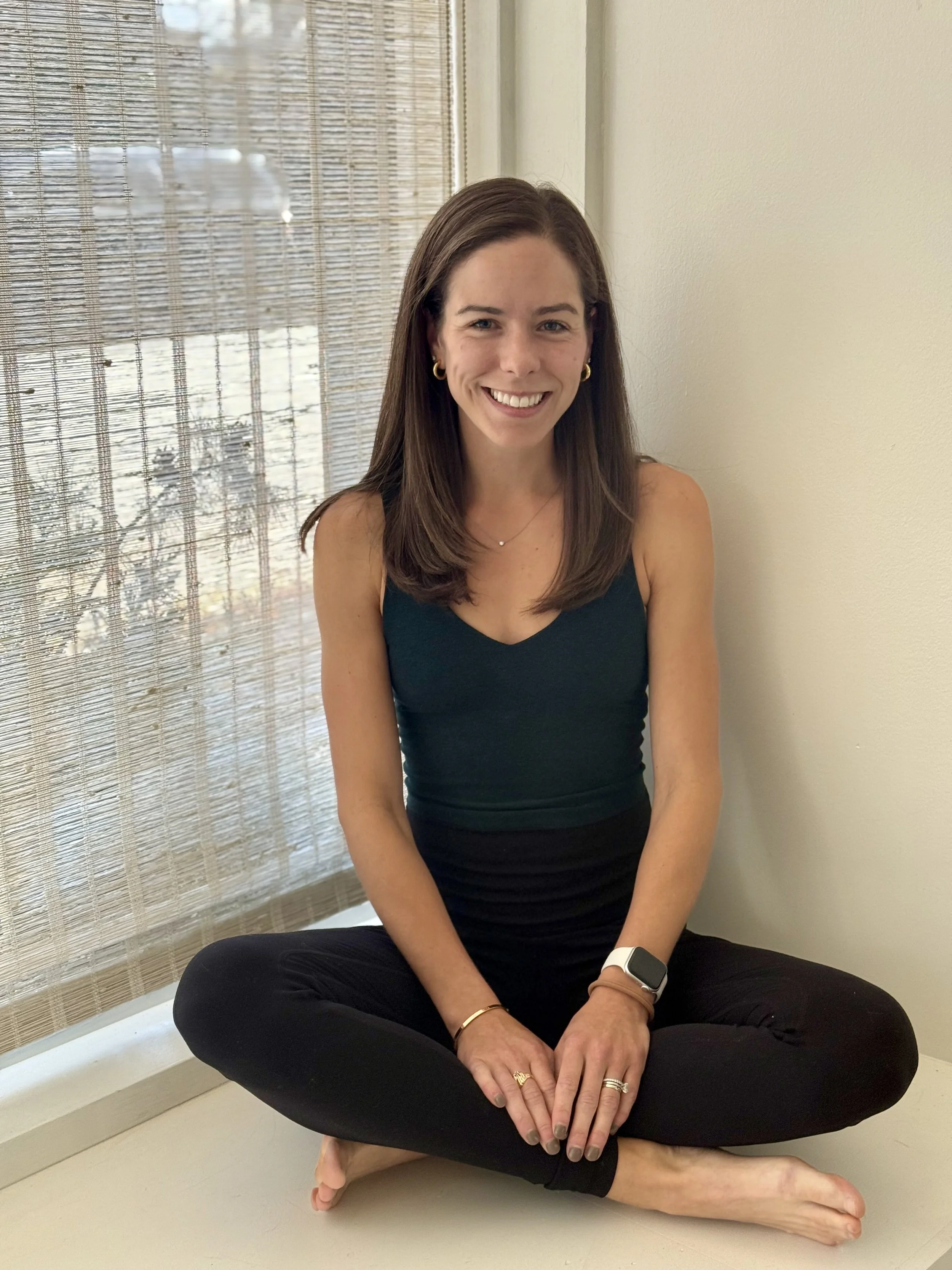 Claire sitting in a window sill