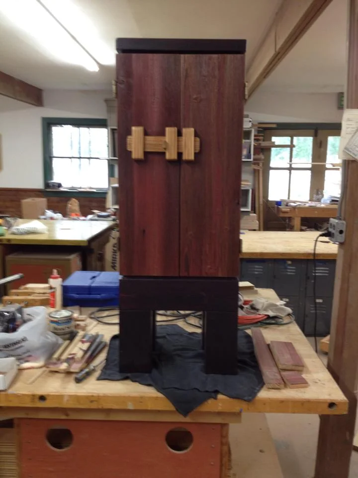With the exception of the hinges, this cabinet is built entirely from reclaimed materials. The base, back and tray top are made from pine salvaged from shipping crates, while the body was once siding on an old barn in Brownsburg, Indiana. The cabinet is 46 1/2" x 12 1/2" x 17". The custom latch is made from more of the same barn siding.