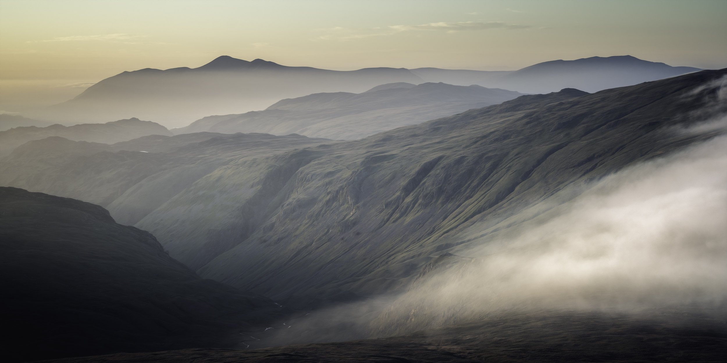 Landscape Photograph of a sunset inversion forming in the Lake District mountains