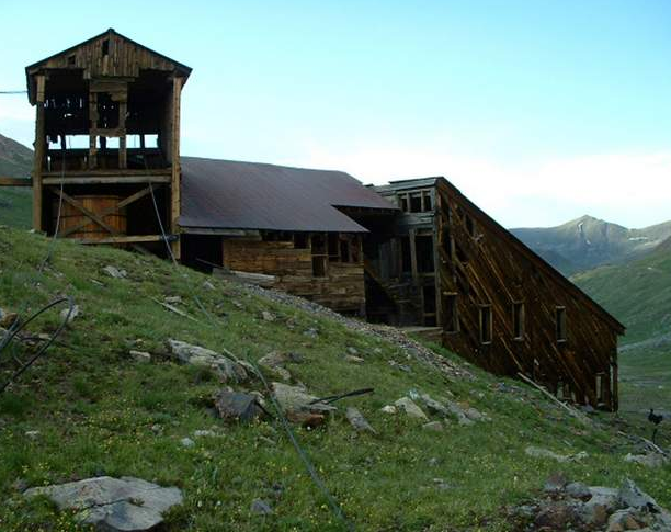 Courtesy of David Singer. The Sound Democrat Mill, thanks to stabilization efforts in the 1990s, now sits intact on a hillside on Placer Gulch northeast of Silverton. Top: The Sound Mill was crumbling before stabilization work.