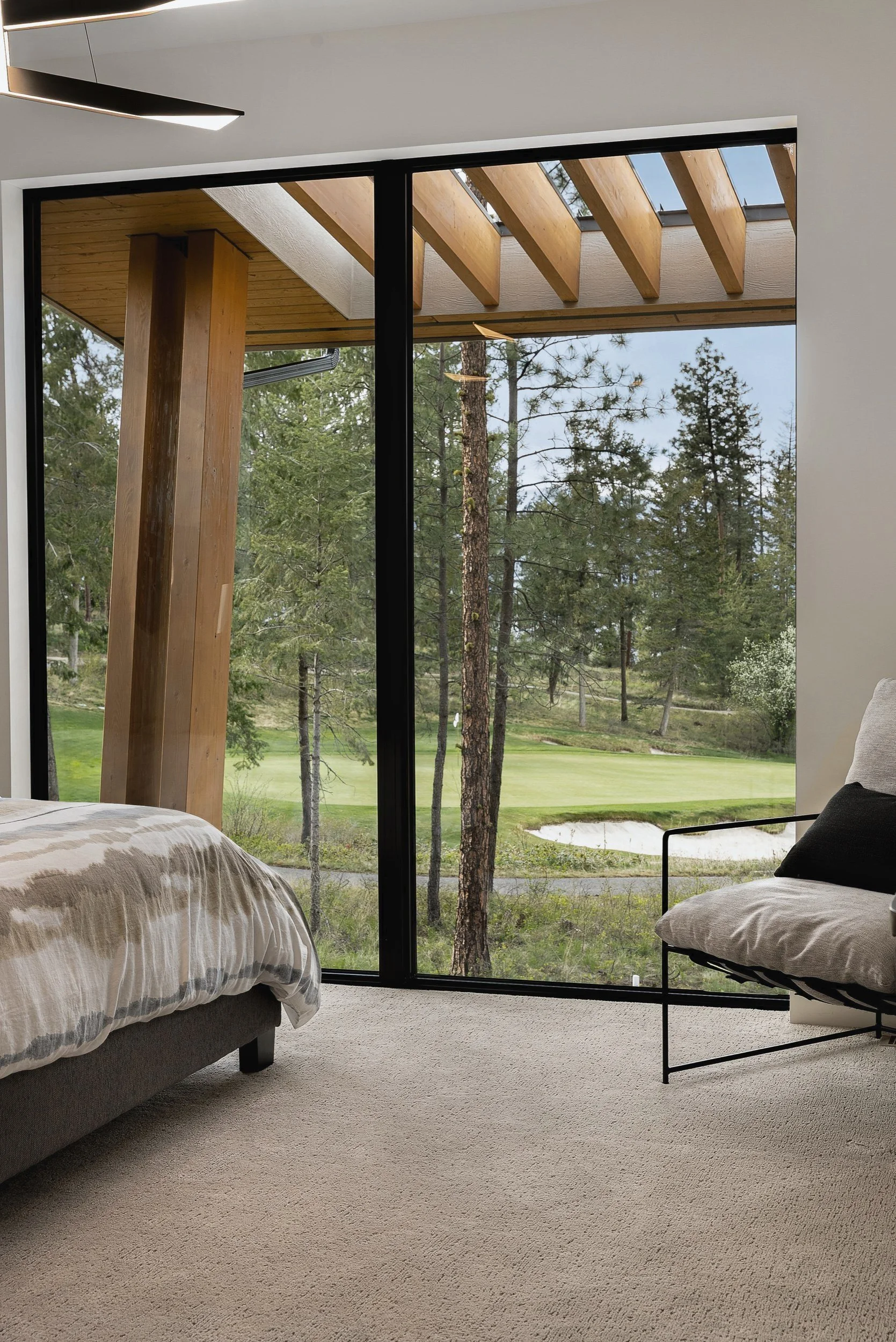 View from the primary bedroom across the covered patio to the green, Green View Residence, Predator Ridge