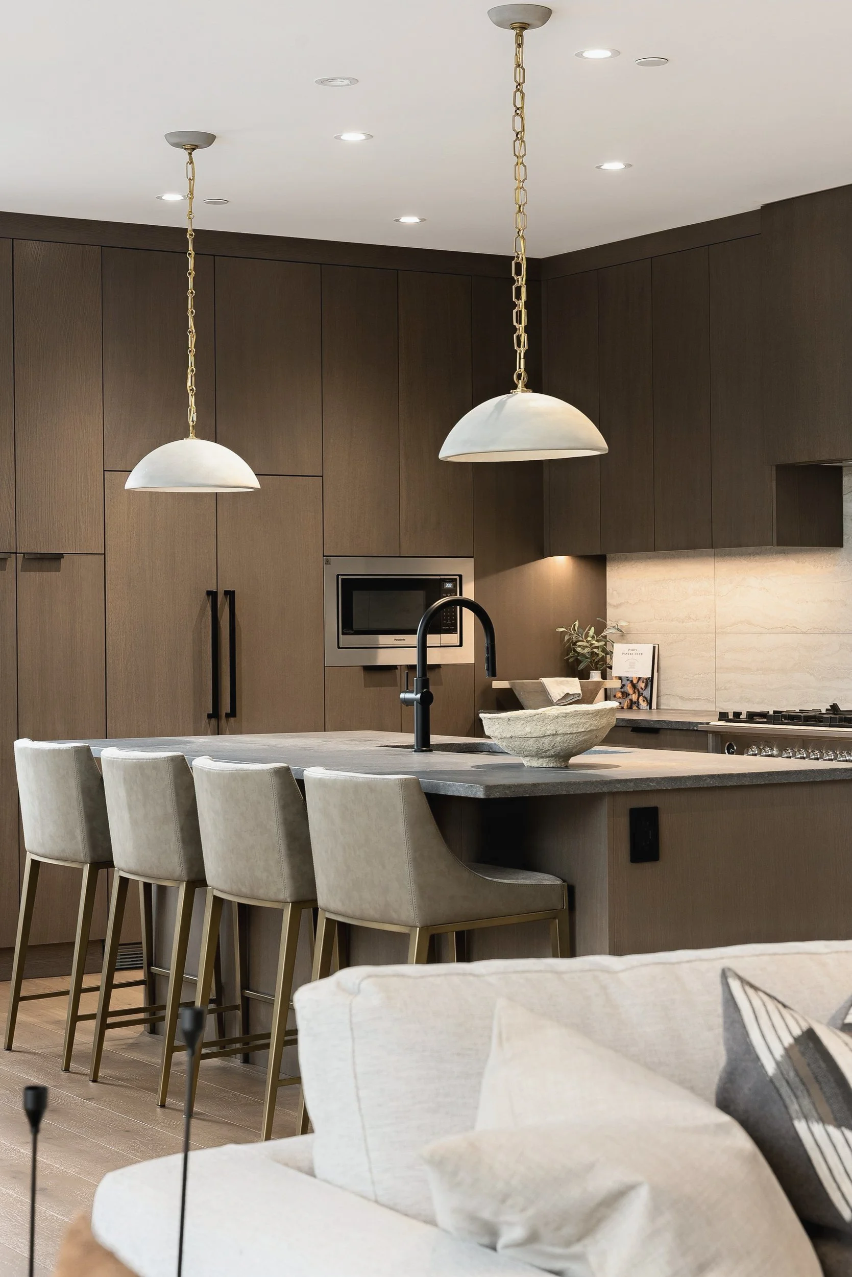 Kitchen island and stools under white dome pendants, Green View Residence, Predator Ridge