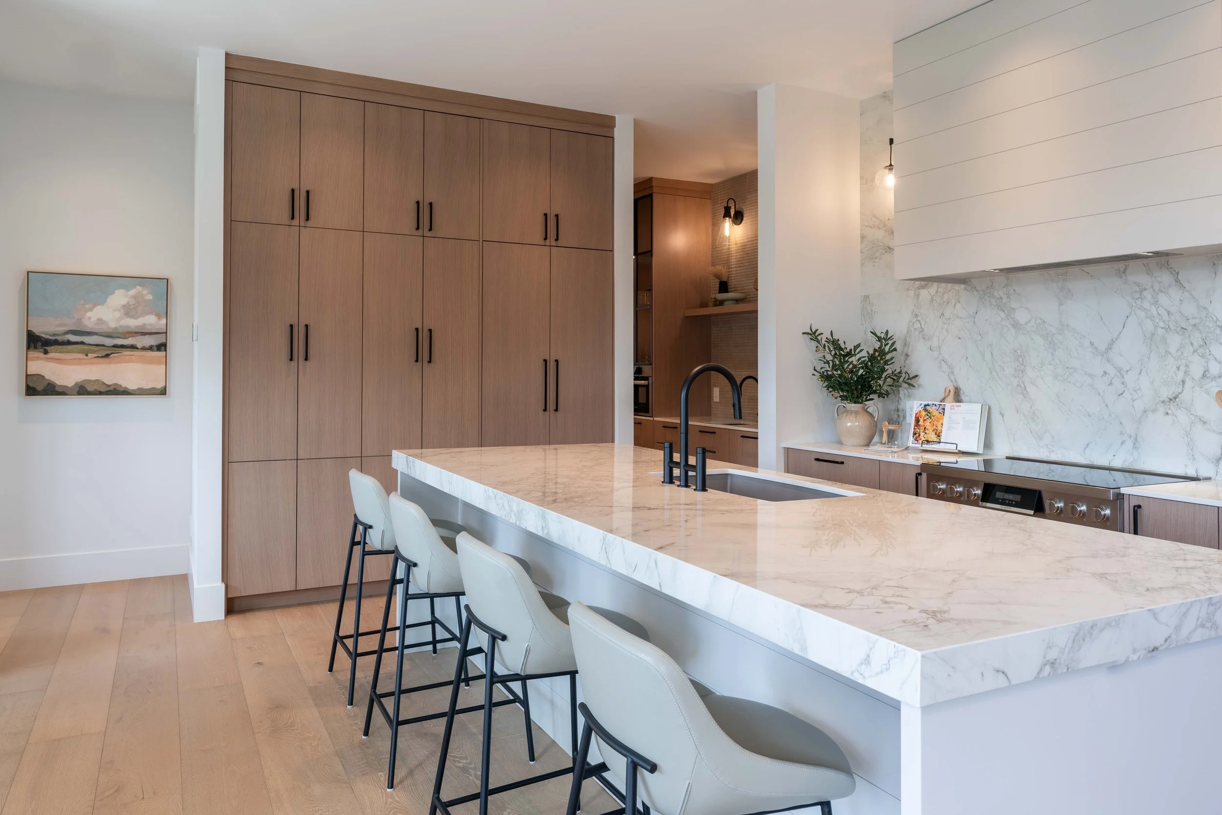 Award-winning modern kitchen design with wood-slat island and stone countertops in Kelowna.
