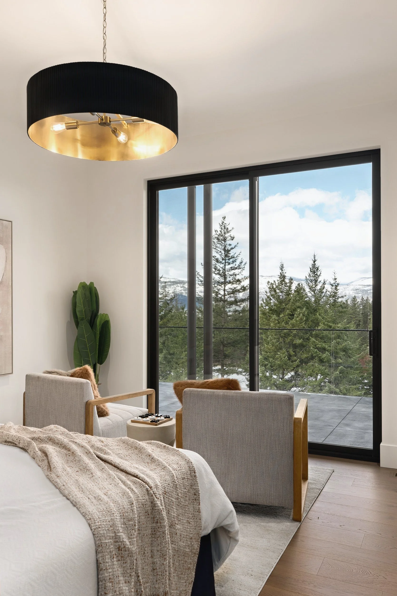Primary bedroom sitting area by the glass, looking out to the trees, Terrace House, Predator Ridge