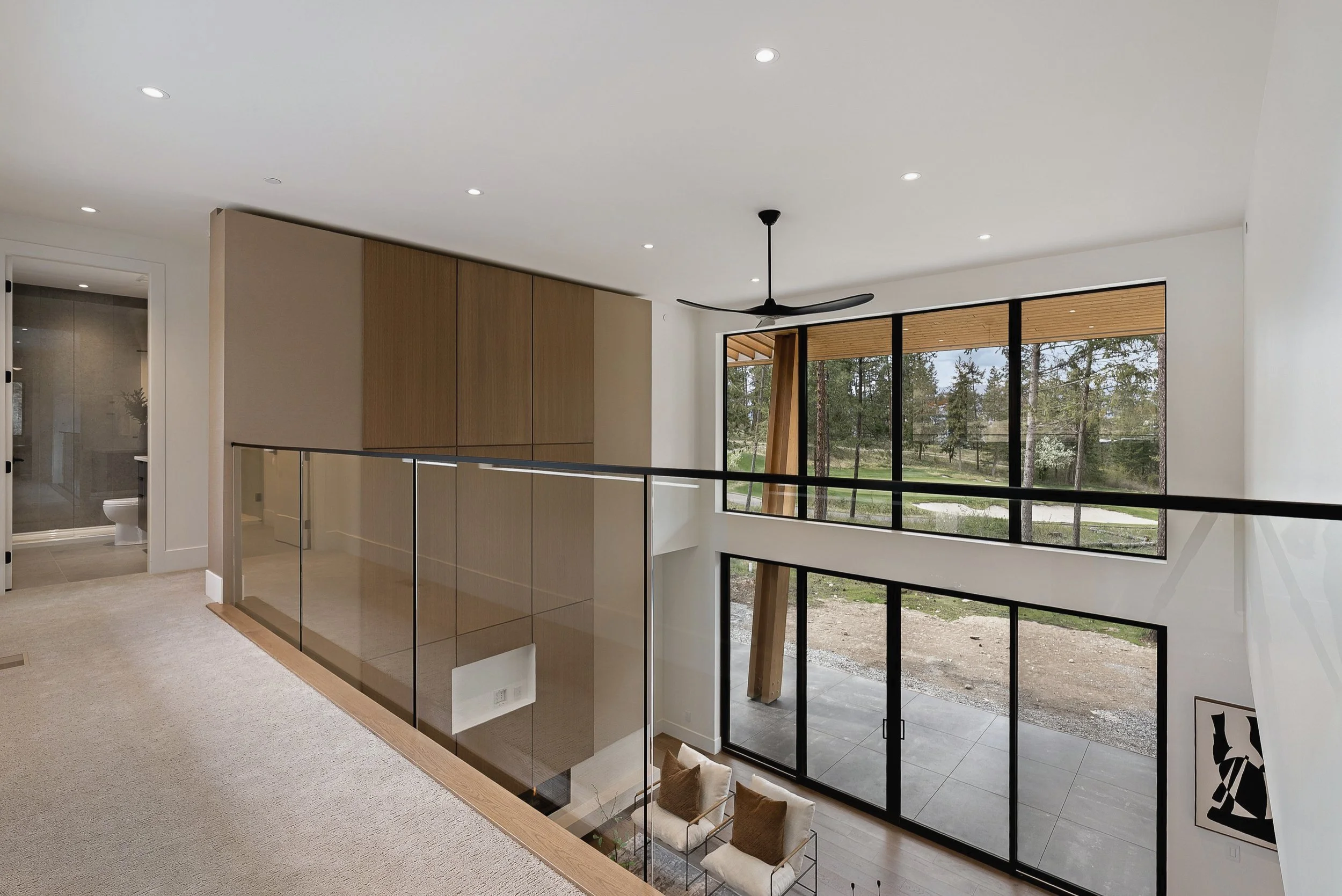 Catwalk with a glass railing above the great room, Green View Residence, Predator Ridge