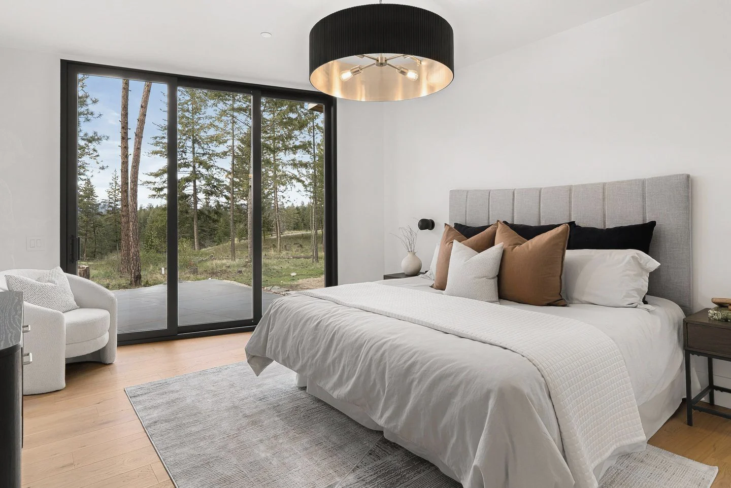 Primary bedroom with a drum pendant and sliding doors to the patio, Fairway Rancher, Predator Ridge
