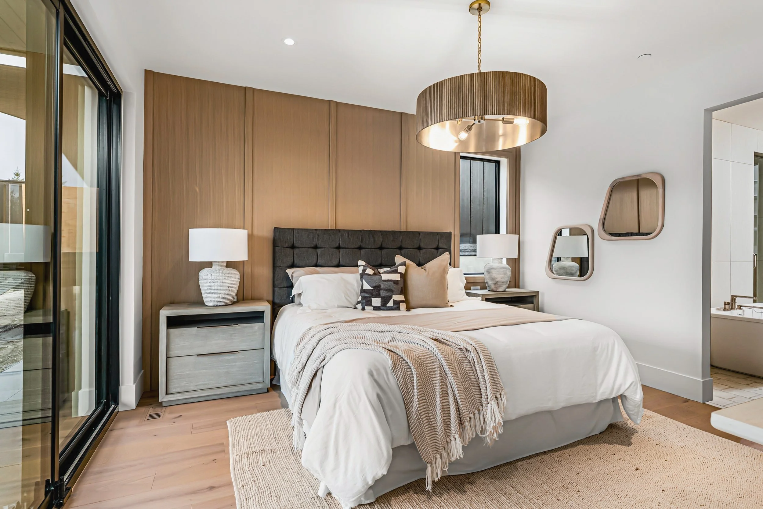 Primary bedroom with an oak feature wall and a drum pendant, Ellison Walkout, Predator Ridge