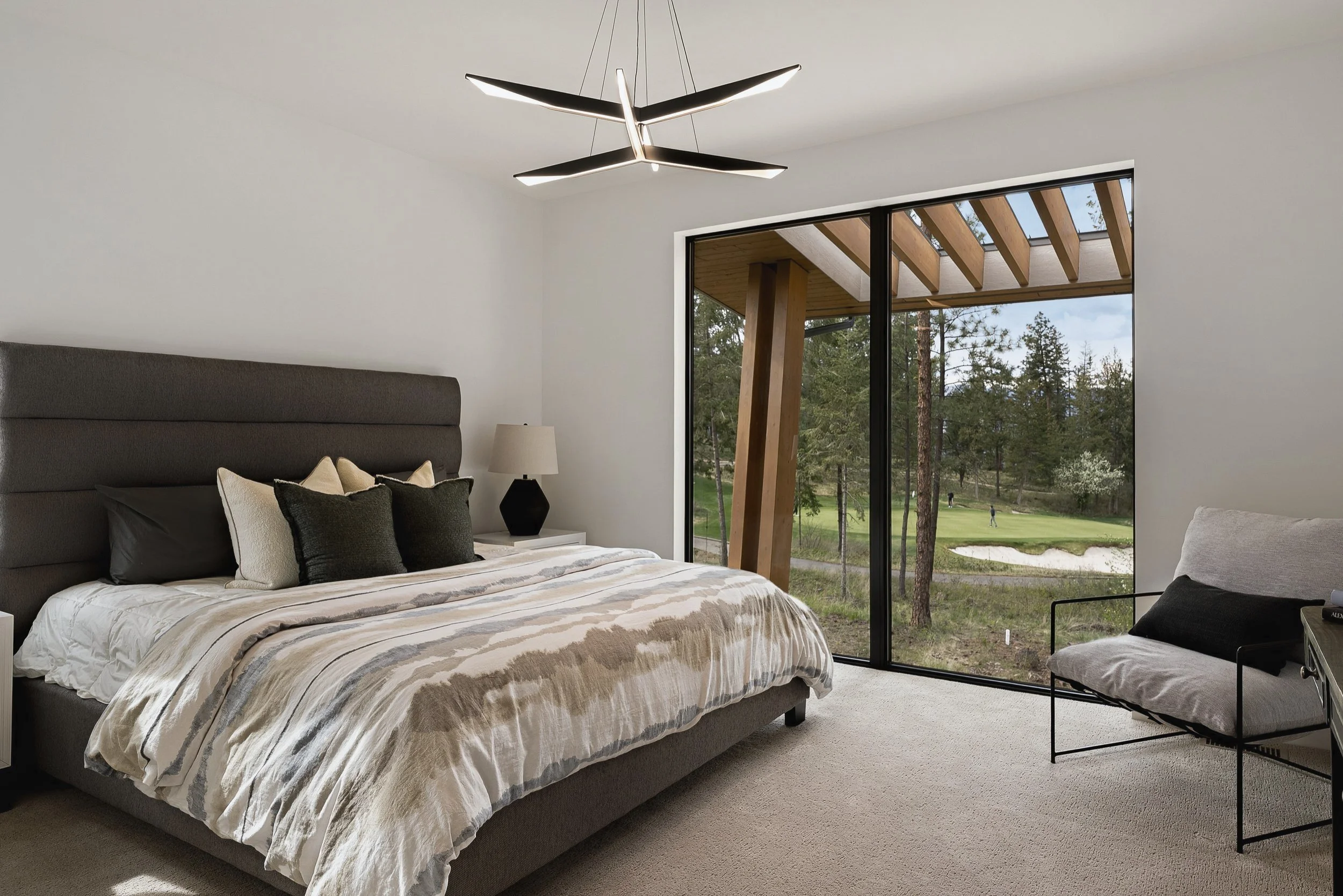 Primary bedroom with a sliding door to the patio and golf course view, Green View Residence, Predator Ridge