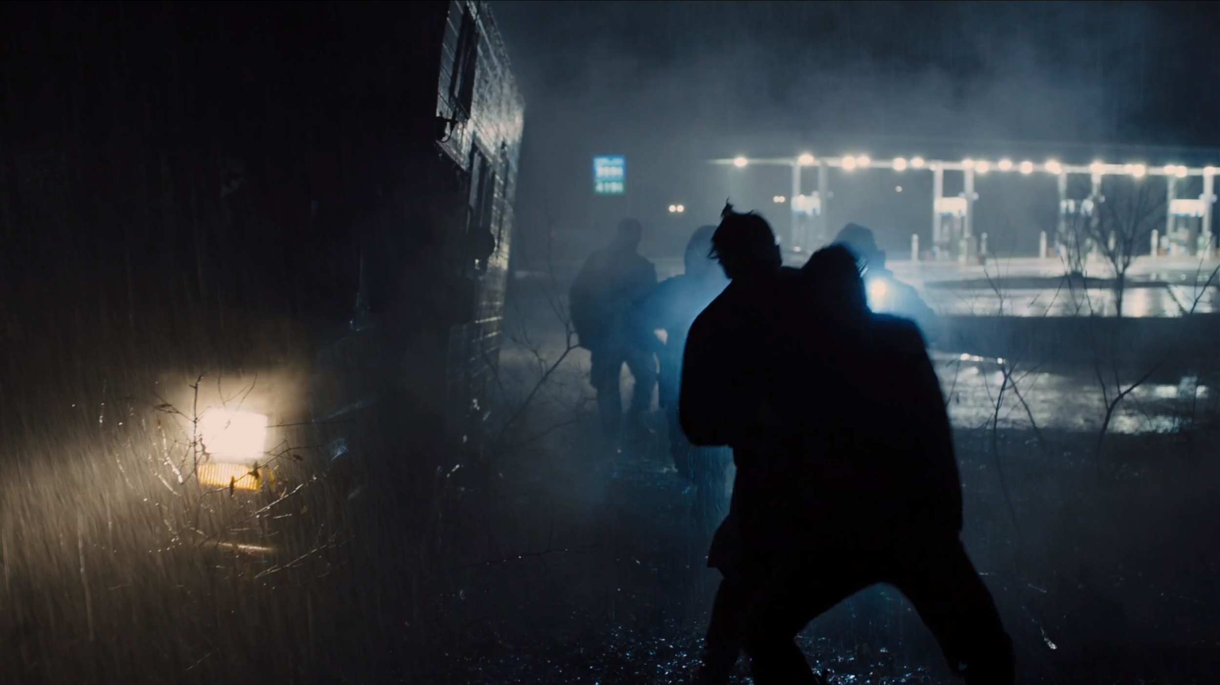 Prisoners - Practical lighting leaves much of the frame in darkness.