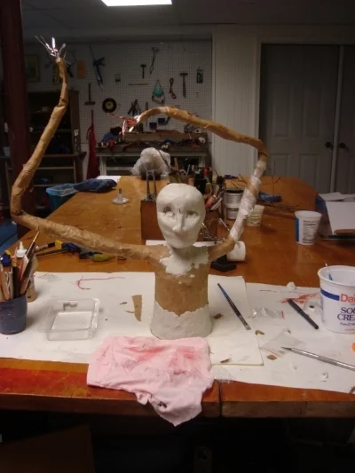   The wire was covered with tape and paper mache. (I think I didn't really need the paper mache. I then used Aves Apoxy “fix- it” as a "textured skin" over the figure. Glass eyes made the figure come to life.  