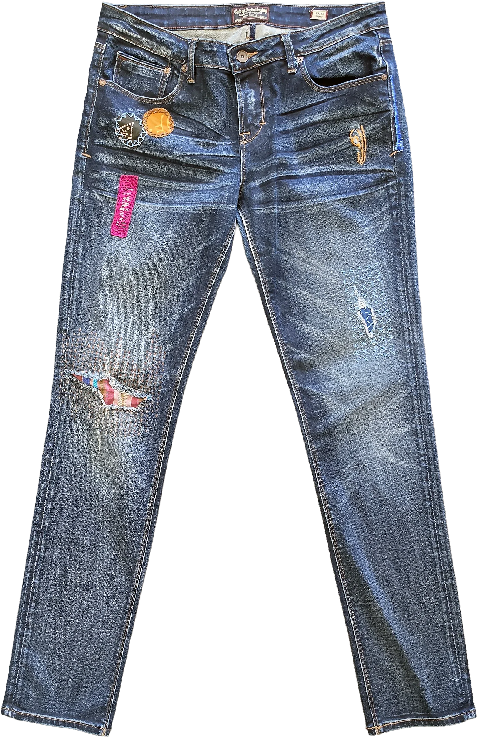 Medium-to-dark wash Cult of Individuality denim featuring multi-point visible mending and hand-stitched embellishments across both legs. Details include a vibrant pink stitched patch and circular appliqués on the upper right hip, contrast thread work