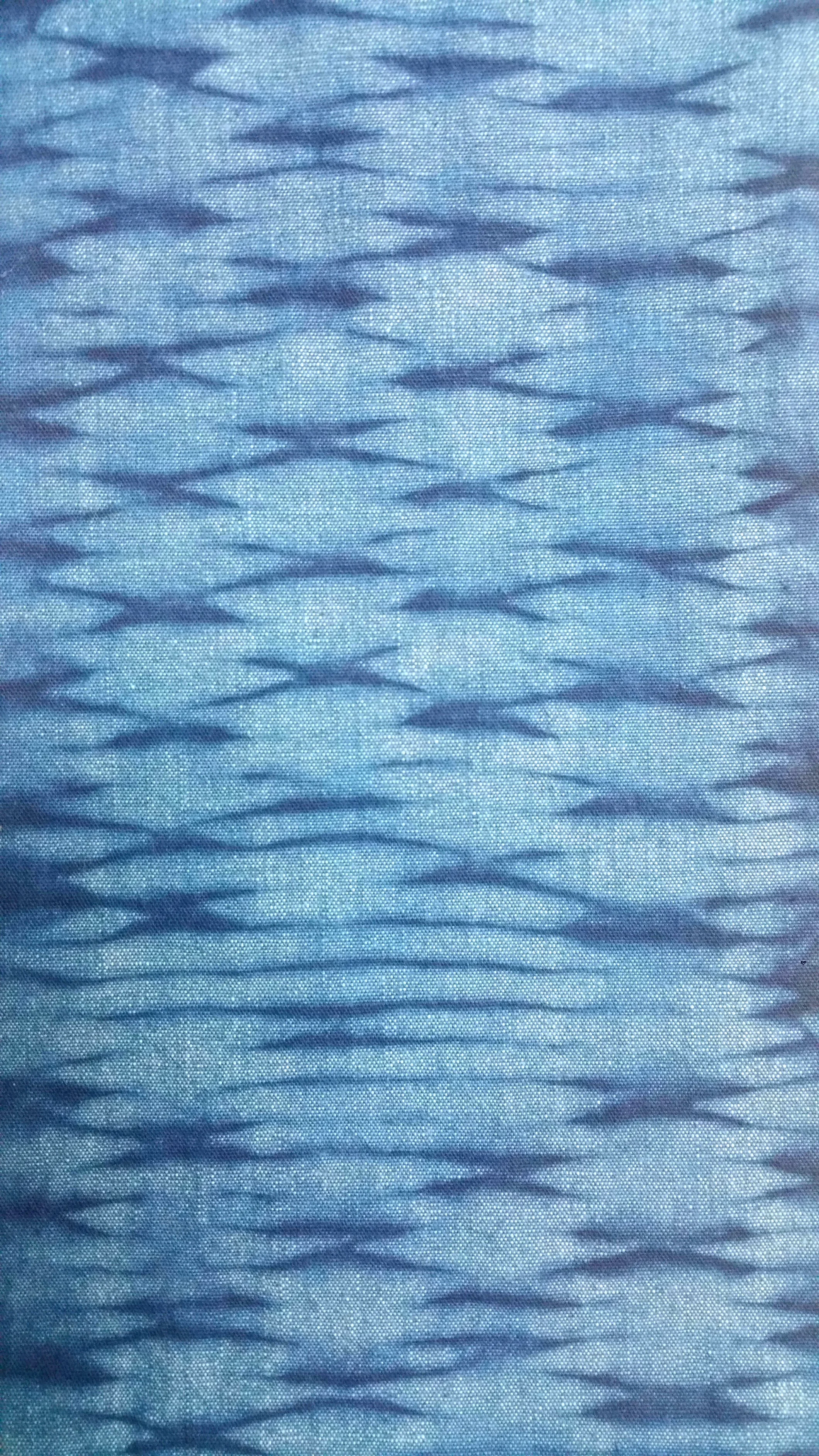 Chambray overdyed in the indigo vat after it was stitched on the Pullen Pleater and manipulated before and during dyeing by Carlyn Clark.
