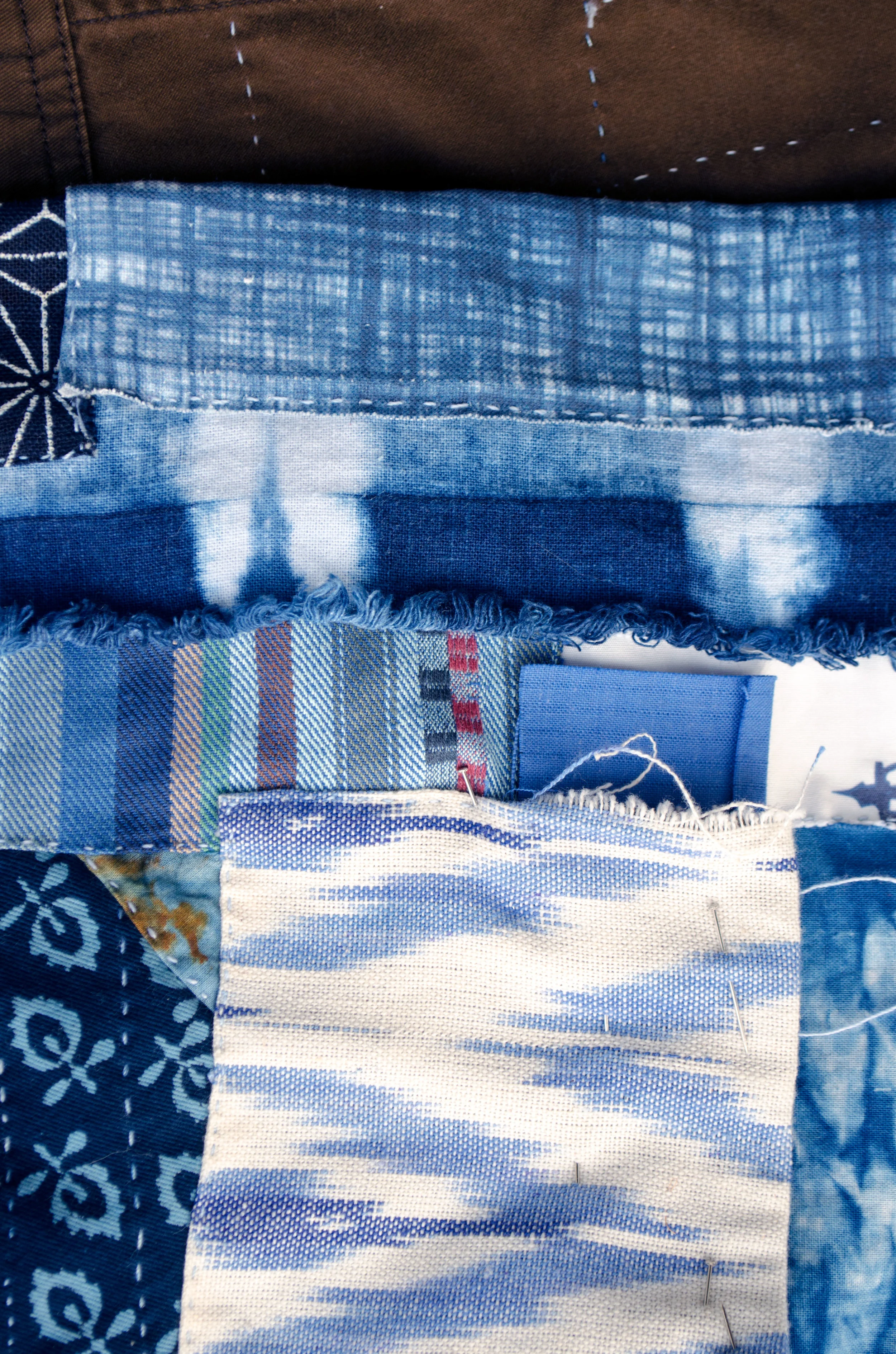 Block printed cotton, ikats, and shibori fabrics patched in the boro style