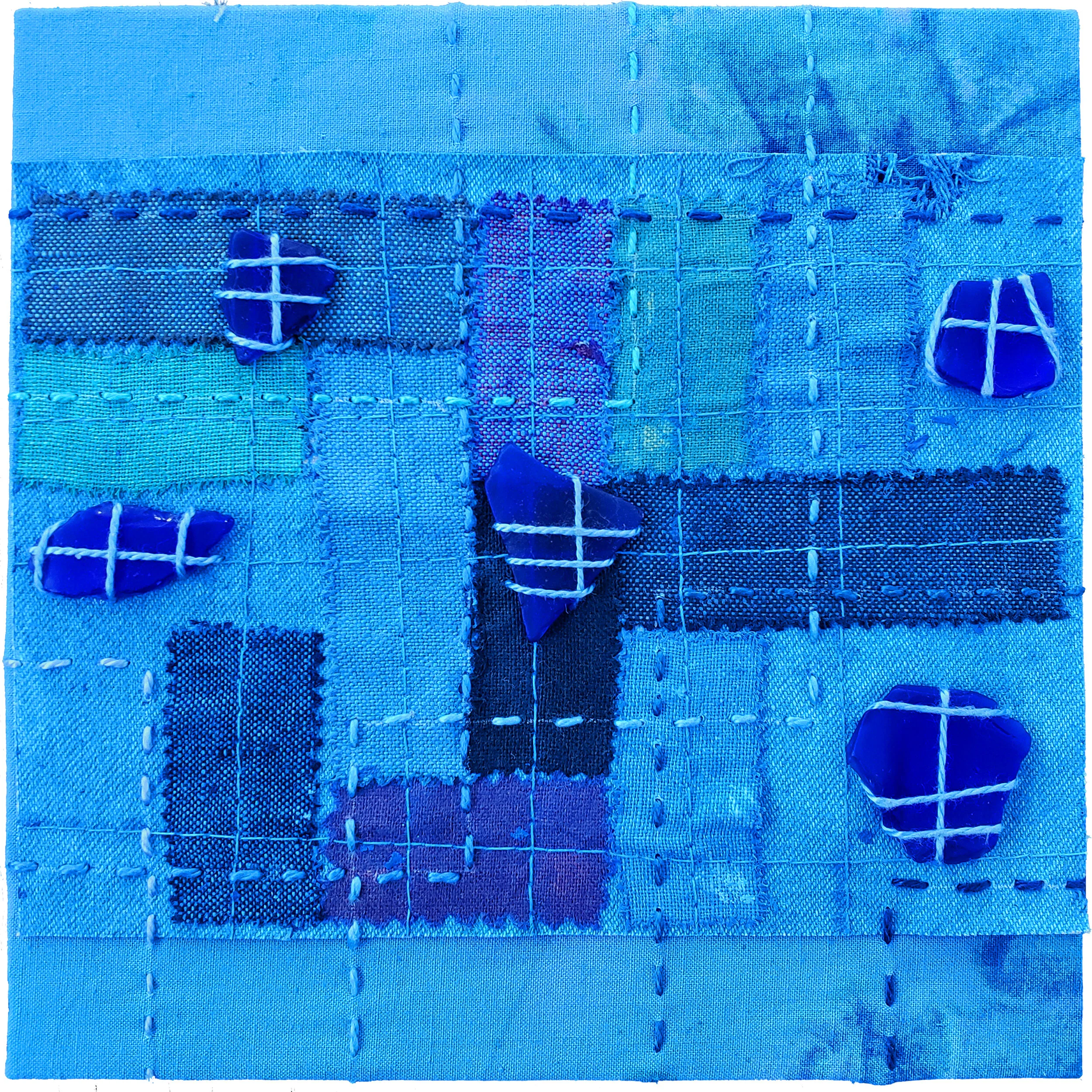  Held in Common: Blue #2  6” x 6” x 3/4” Indigo-dyed fabric, hand-stitched with scavenged sea glass, block printing, and industrial waste offcuts, laminated onto a Baltic birch plywood panel